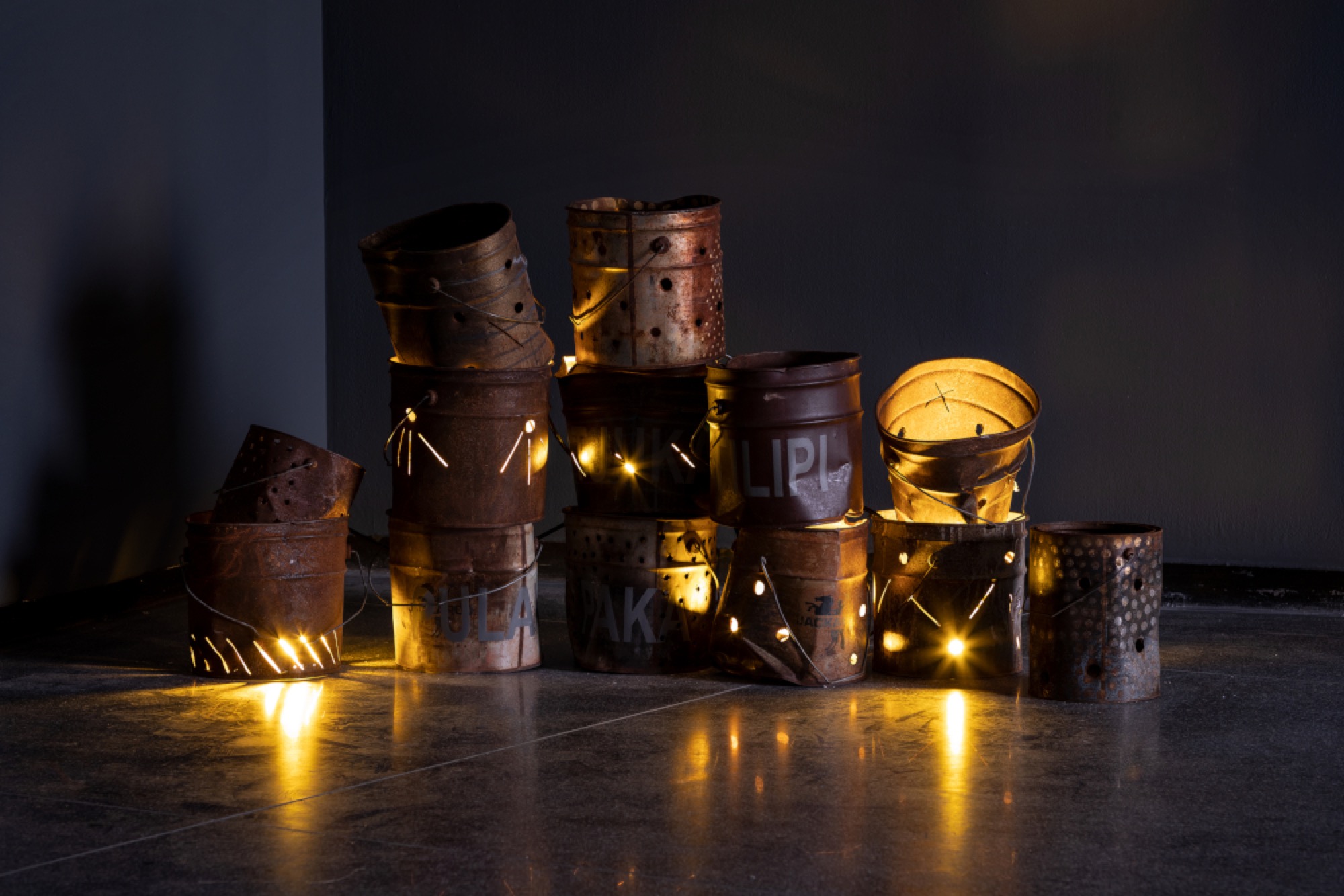 Robert Fielding, <em>Untitled</em> 2018, found flour buckets, lights, dimensions variable, installation view, Australian Centre for Contemporary Art, Melbourne. Courtesy the artist and Mimili Maku Arts, Mimili Community, South Australia. Photograph: Andrew Curtis.