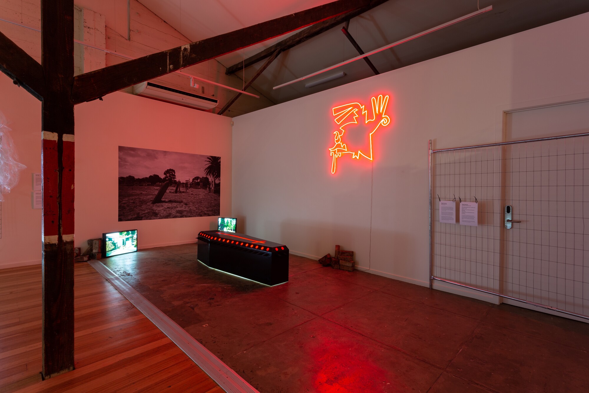 Diego Ramirez, <em>Eternal Arrival,</em> 2019. Coffin-shaped lightbox; Diego Ramirez, <em>The Infinity of The Past</em>, 2019. Neon; Diego Ramirez, <em>i want 2 die in mexican soil, so please don’t kill me yet,</em> 2022. Wallpaper; Diego Ramirez, <em>when you arrive i am the cat that loves a dog</em>, 2022. Duratran in lightbox; Diego Ramirez, <em>when you leave i am the dog that loves a cat</em>, 2022. Duratran in lightbox. Courtesy the gallery. Photo: Lucy Foster
