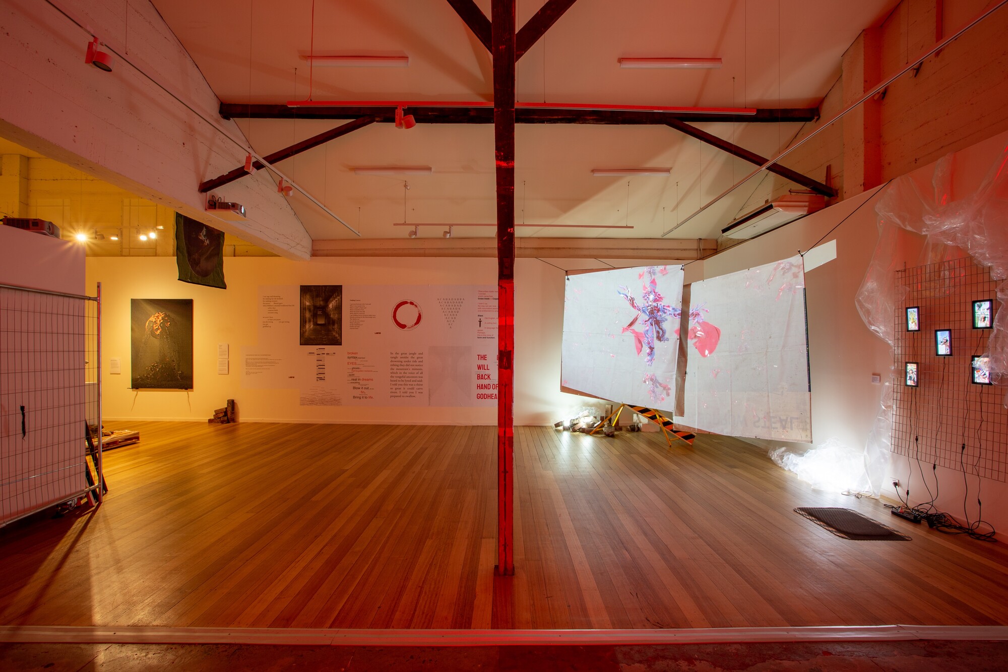 Installation view of <em>Aeon Resurrection</em>, 2022. Nicholas Aloisio-Shearer, <em>Reject Modernity, Embrace Tradition II: I Have Been In This Place Before,</em> 2021. Jacquard woven tapestry, silicon, pigment, aluminium, resin and bronze pigment; Thin Red Lines, <em>untitled,</em> 2022. Paste up poems on copy paper, excerpts collected in 2022; Huntrezz Janos, <em>video,</em> 2022. 3D video animation; Huntrezz Janos, <em>face filters</em>, 2022. Virtual and augmented reality face filters. Courtesy the gallery. Photo: Lucy Foster