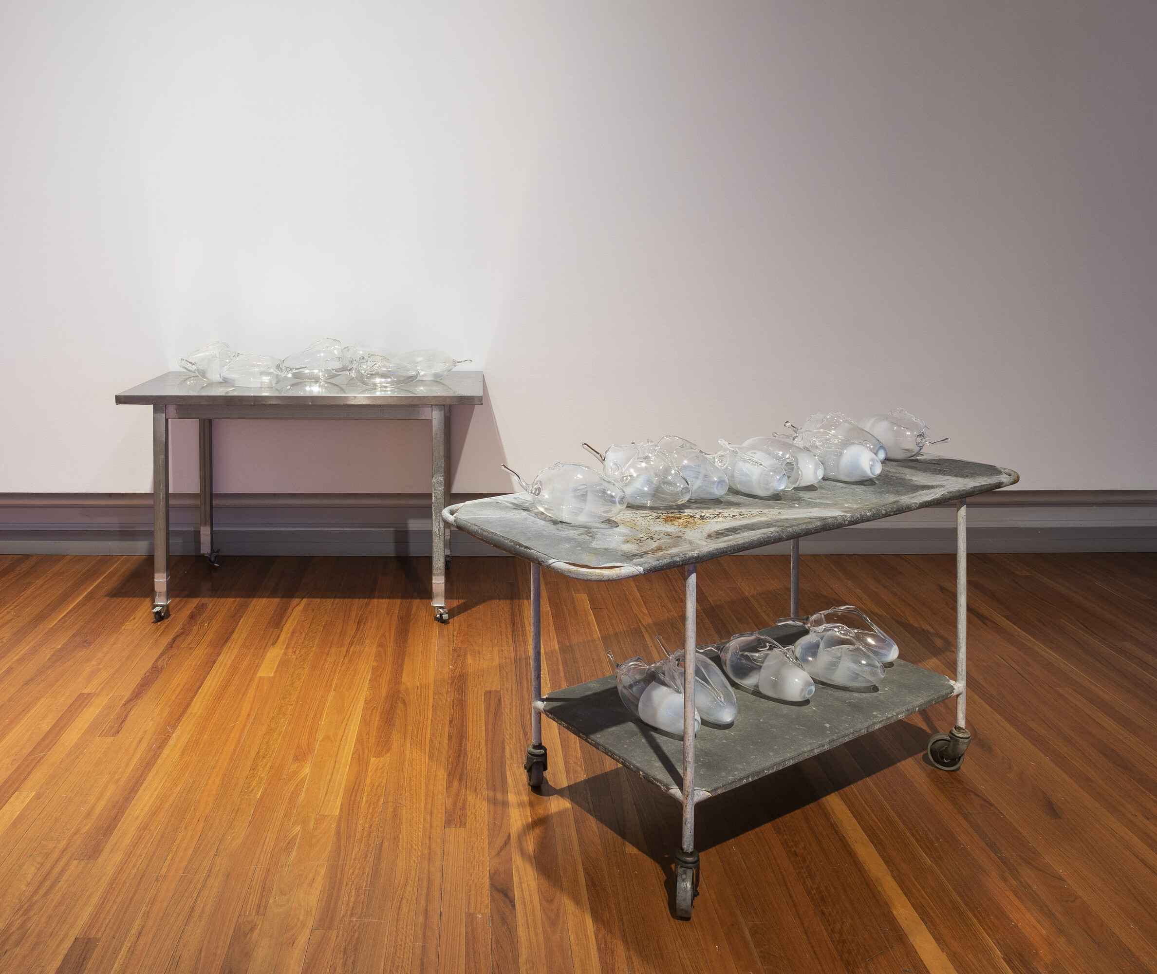 Yhonnie Scarce, <em>In the dead house</em>, 2020. Blown glass bush bananas and vintage mortuary table. Image courtesy of RMIT Gallery. Photo: Tobias Titz