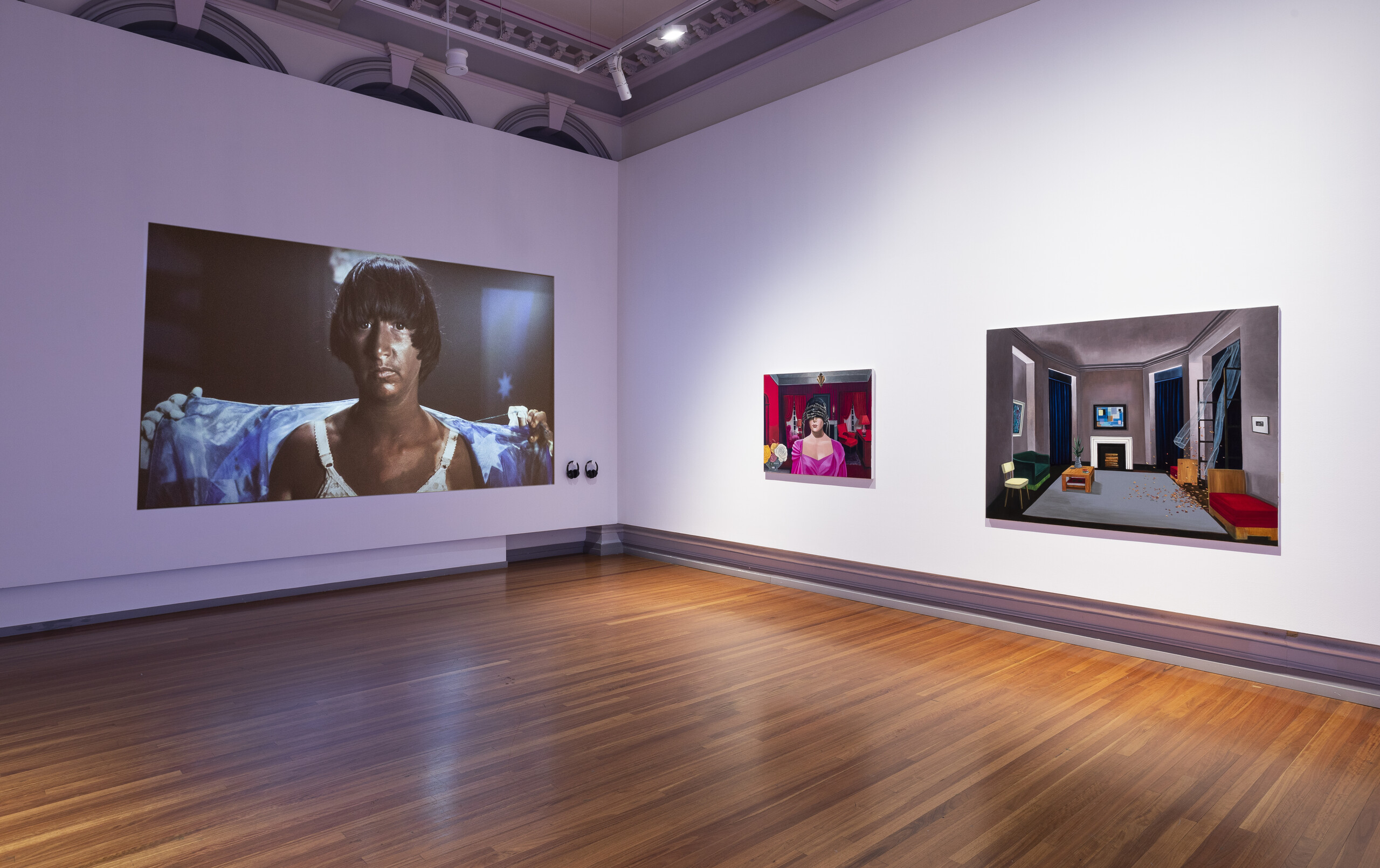 Installation view of <em>Agent Bodies</em> 2022, RMIT Gallery. Megan Cope, <em>THE BLAKTISM</em>, 2014. Digital video (7:00); Anne Wallace<em>,</em> <em>Pythoness</em>, 2022. Oil on linen; Anne Wallace, <em>Arrangement,</em> 2022. Oil on linen.  Image courtesy of RMIT Gallery. Photo: Tobias Titz