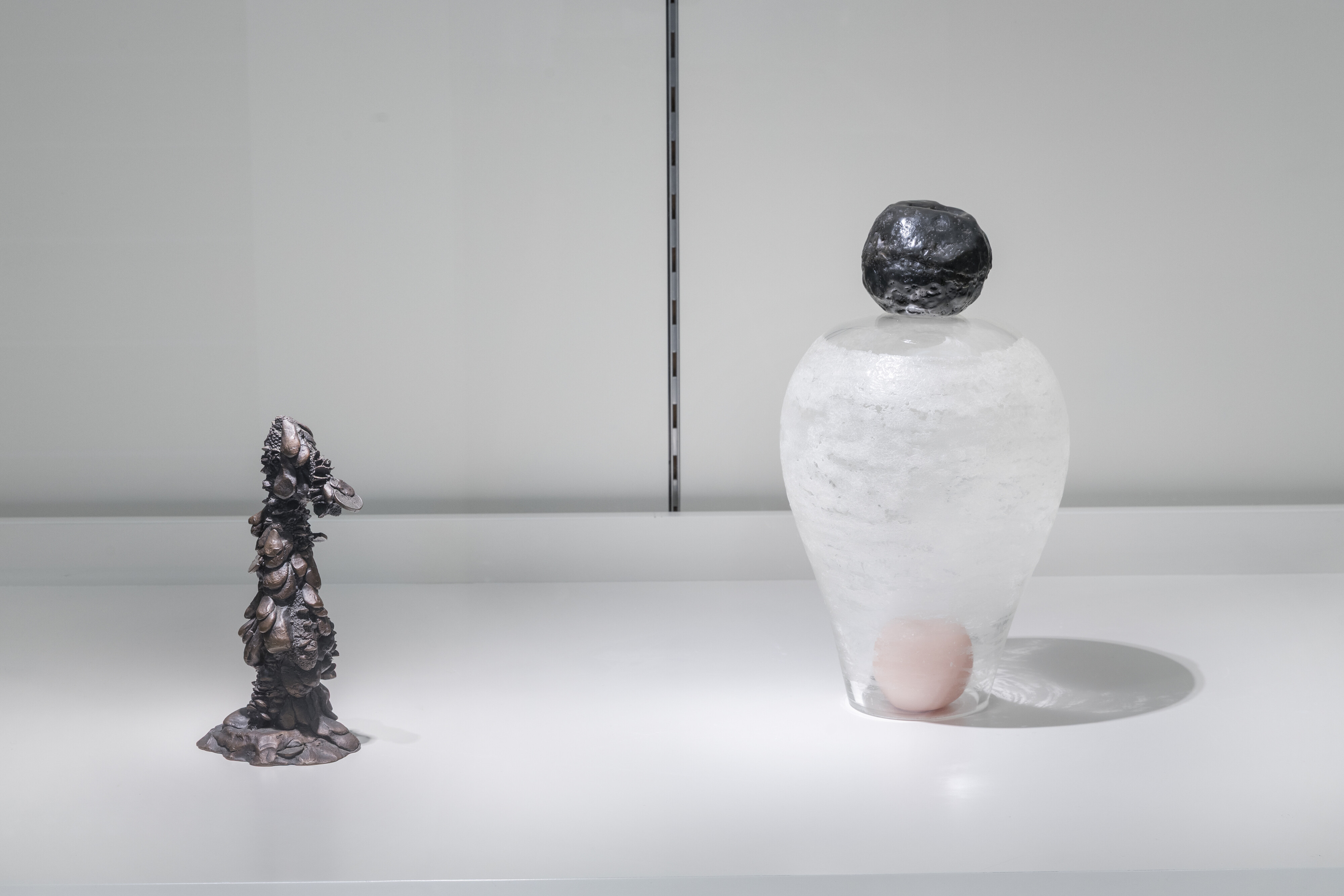 <p>Installation view of Nicholas Mangan, <em>Monument for Small Change,</em> 2007, bronze, edition 37/50 and Benjamin Armstrong, <em>Pink and Black</em>, 2009, blown glass and wax. Photo: Andrew Curtis, courtesy of Geelong Gallery.</p>