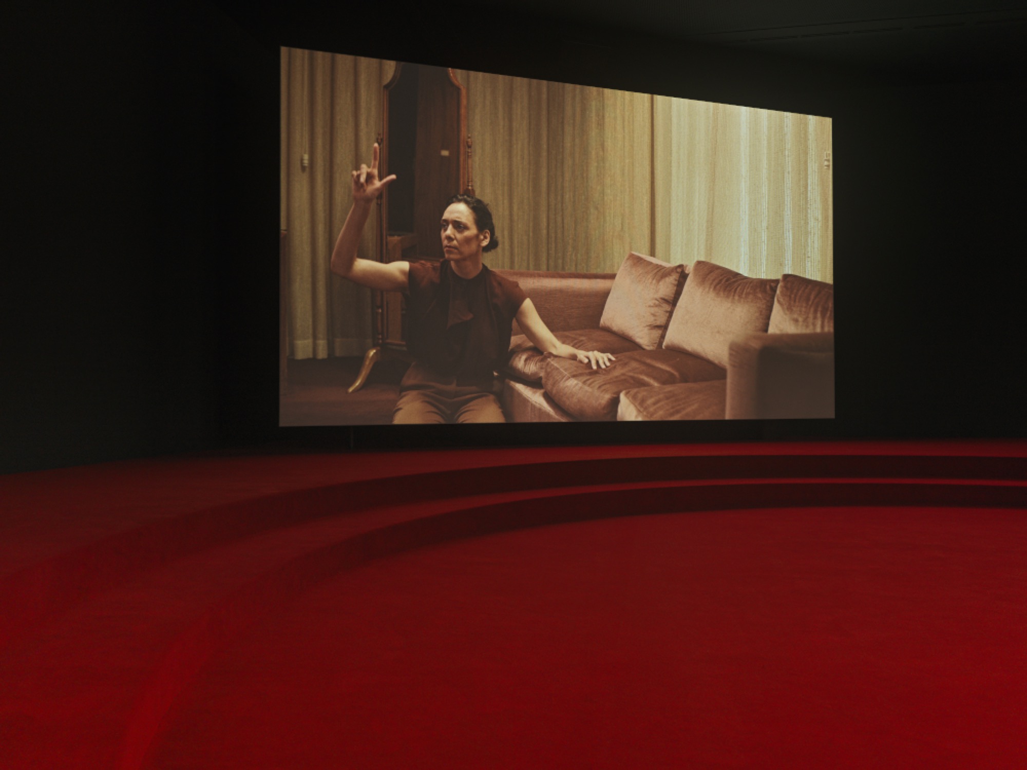 Angelica Mesiti, <em>ASSEMBLY</em>, 2019 (installation shot) three-channel video installation in architectural amphitheater. HD video projections, color, six-channel mono sound, 25 mins, dimensions variable. © Photography: Josh Raymond. Commissioned by the Australia Council for the Arts on the occasion of the 58th International Art Exhibition–La Biennale di Venezia. Courtesy of the artist and Anna Schwartz Gallery, Australia and Galerie Allen, Paris.
