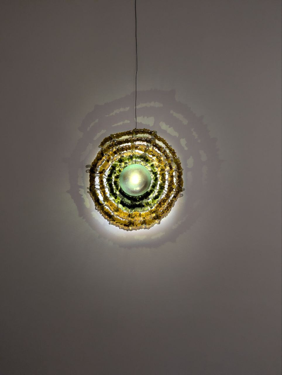 <p>Tamara Henderson, <em>Web Wall Light Green</em>, 2025. Fused bullseye glass. 60 x 60 x 2. </p>