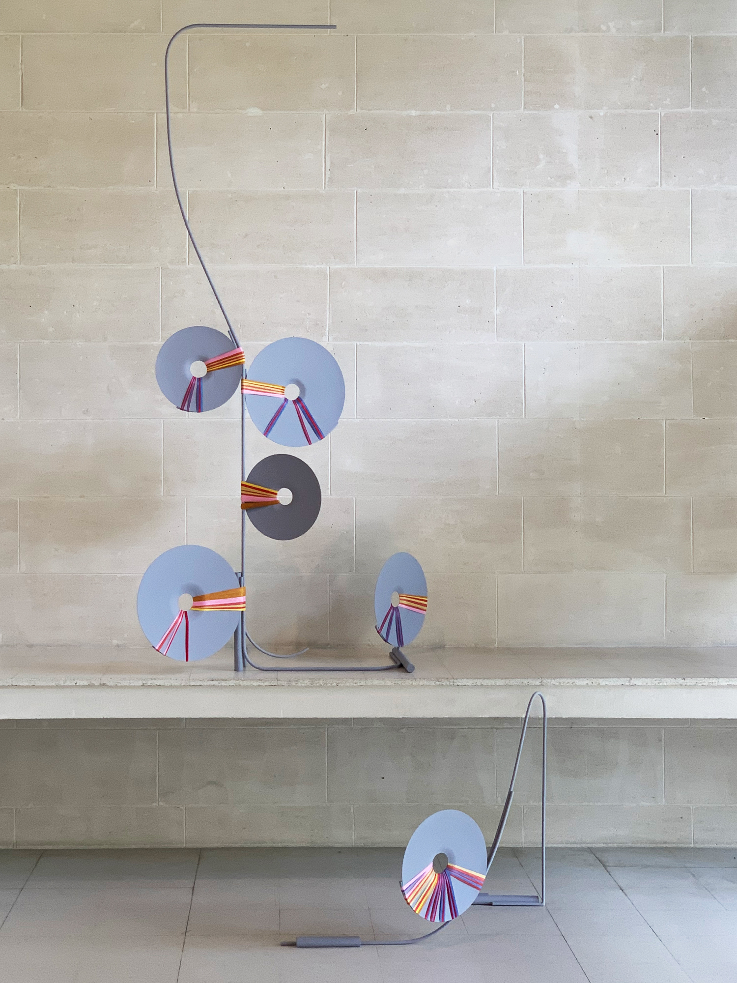 Installation view of Mira Gojak, <em>Attachments of Colour</em>, 2022, readymade cymbals, synthetic polymer paint, steel, cotton thread. Image courtesy of Murray White Room