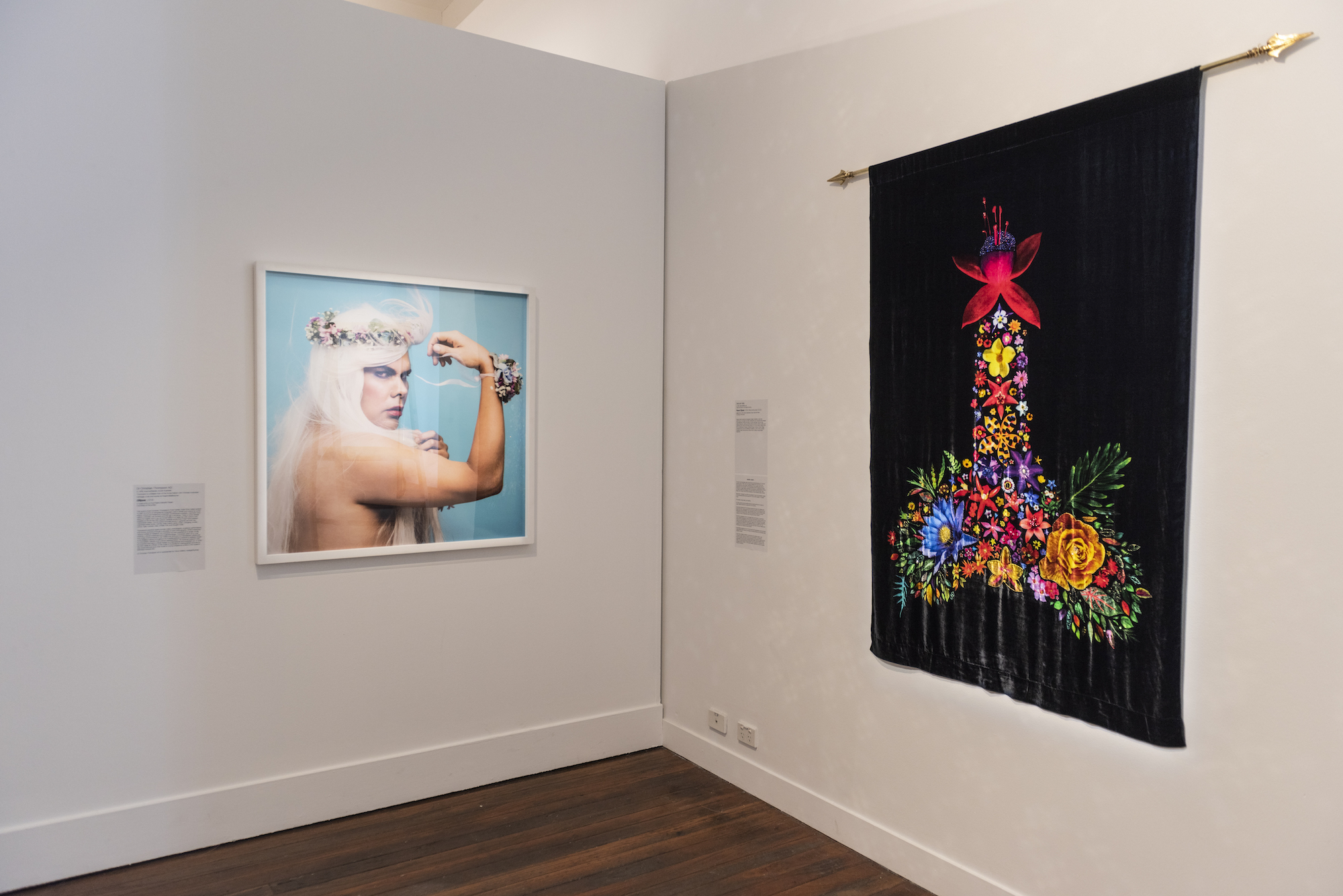 Installation view of Deborah Kelly, <em>Floral C(I)ock</em>, 2004 (Reconstructed 2023), digital print on silk velvet, diamantes, brass rods and finials. Embroidery: Eddie Bosnich. Additional Beading: Kit Spencer, Poppy Tiegel. Dr Christian Thompson AO, <em>Ellipse</em>, 2014, C-type print on Fuji Pearly Metallic Paper. Photo: Peter Morgan