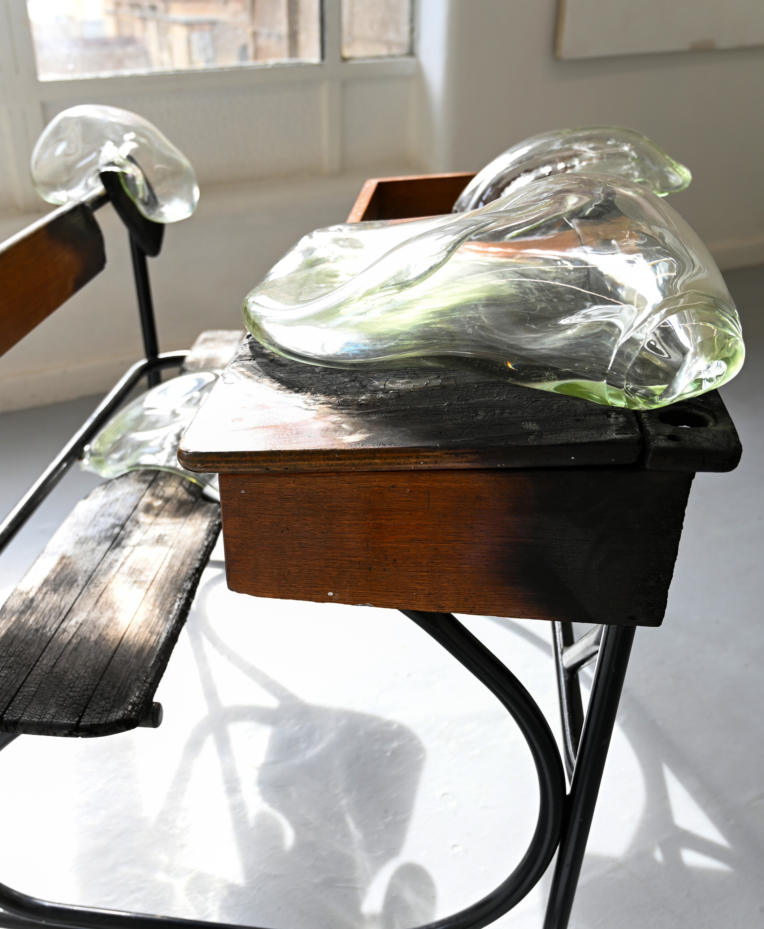 <p>Detail view of afra küllü, <em>Go Educate Yourself</em>, 2024, Children’s school desk, blown glass. Dimensions variable. Photo: Storm Gold.</p>