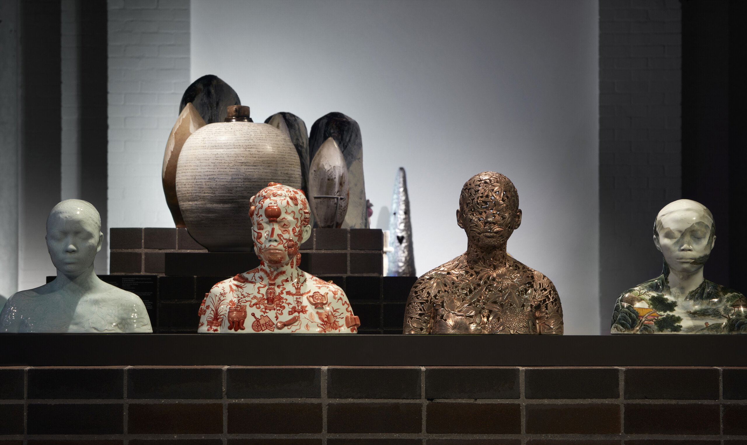 Ah Xian, <em>China - Busts 28’ 34’ 39’ 60’</em>, porcelain body-cast with yingging glaze on relief floral carving design, Jiangxi Province, China, 1999. Photo: Zan Wimberley