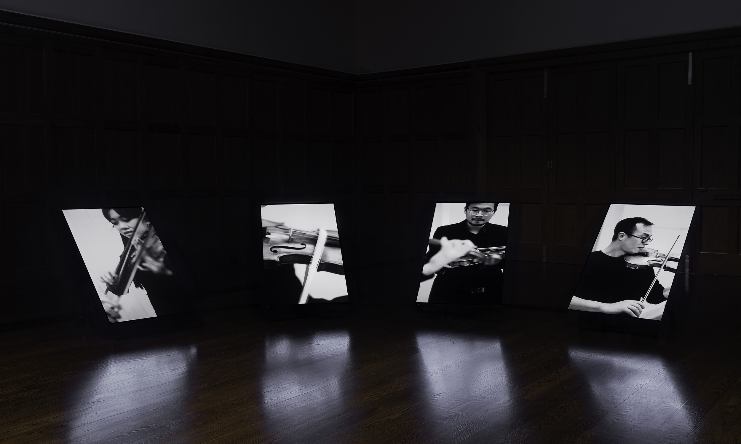 Installation view of James Nguyen, An Australian National Song 2022, 4-channel video, 8:55 min. On display in Collective Unease at the Ian Potter Museum of Art, Old Quadrangle, University of Melbourne. Photo: Christian Capurro. Courtesy of the curators.