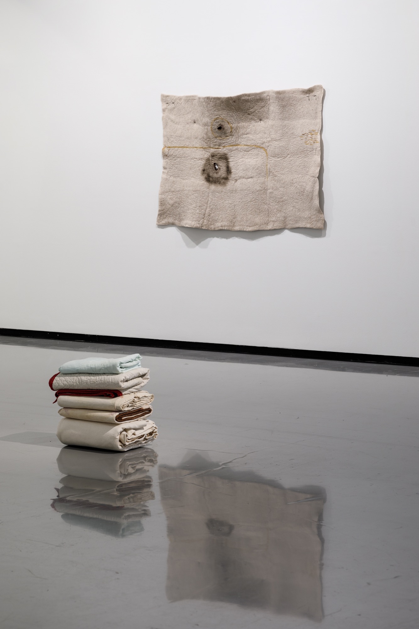 Kate Harding, <em>Birth and ten-year-old quilts 2021 and Dale Harding, Cloaks (mortua and mortuus)</em> 2018, <em>Repression cloak (ceremony for a gay wedding)</em> 2018, <em>Untitled cloak</em> 2018 and <em>F1 (Saddler’s contract)</em> 2020. Installation view, <em>Dale Harding: Through a lens of visitation</em>, Monash University Museum of Art, Melbourne, 2021. Photo: Andrew Curtis. Image courtesy of the artist and Milani Gallery, Brisbane.