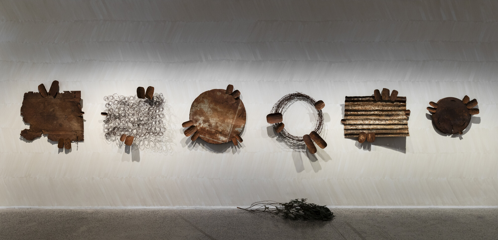 <p>Installation view, <em>Dhuluny: the war that never ended</em>, Bathurst Regional Art Gallery, 6 July – 8 September 2024, featuring Lorraine Connelly-Northey, <em>Possum-skin cloaks: Waradgerie Winnowers</em>, 2024, rusted iron and tin, barbed wire, and wire. Courtesy the artist. Photo: Silversalt Photography</p>