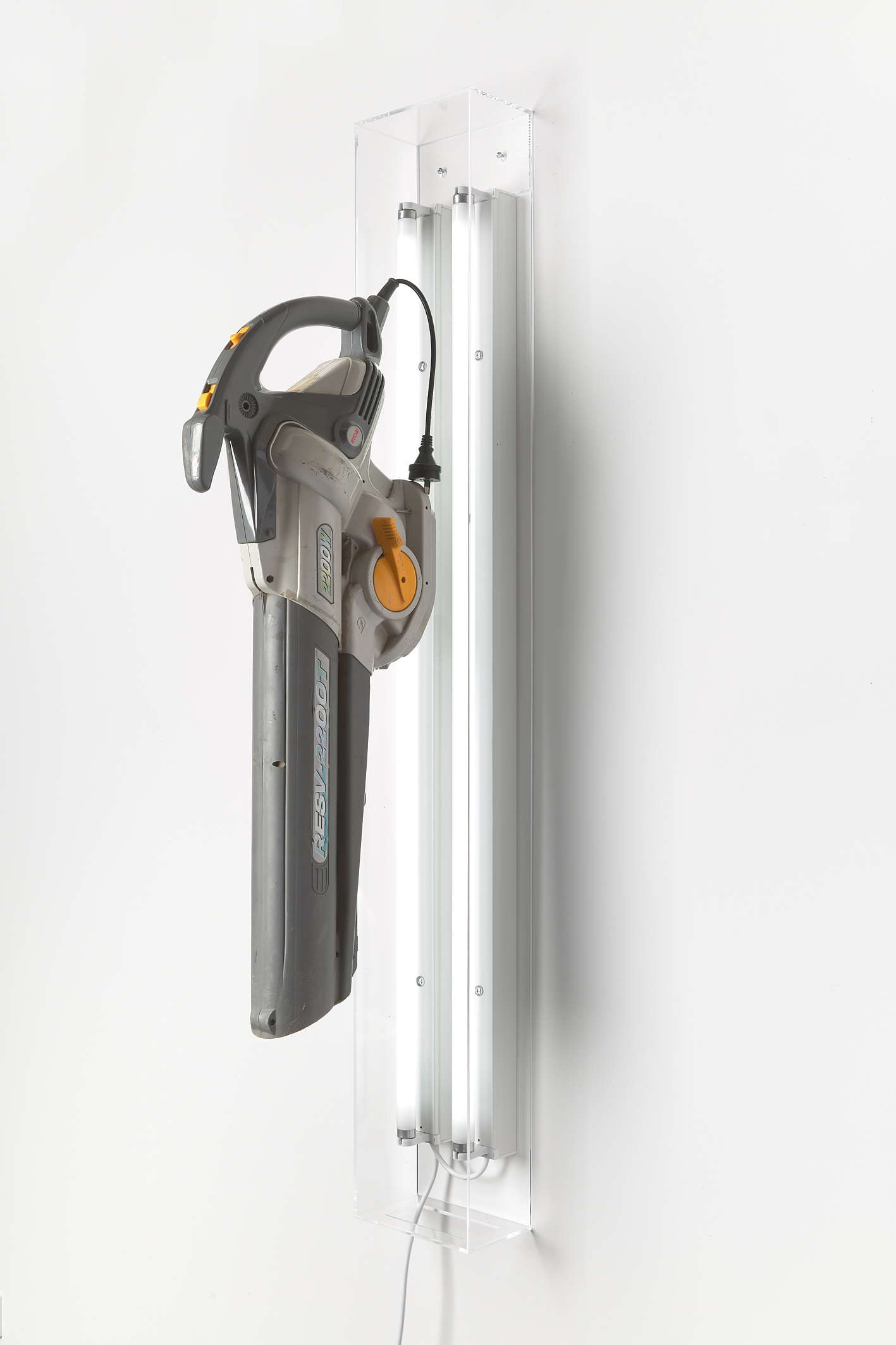 David Attwood, <em>Post New Ryobi RESV2200T</em>, 2022, Ryobi RESV2200T Electric Leaf Blower Vacuum, fluorescent lights, acrylic, 142 x 20 x 40 cm. Photo: Christo Crocker