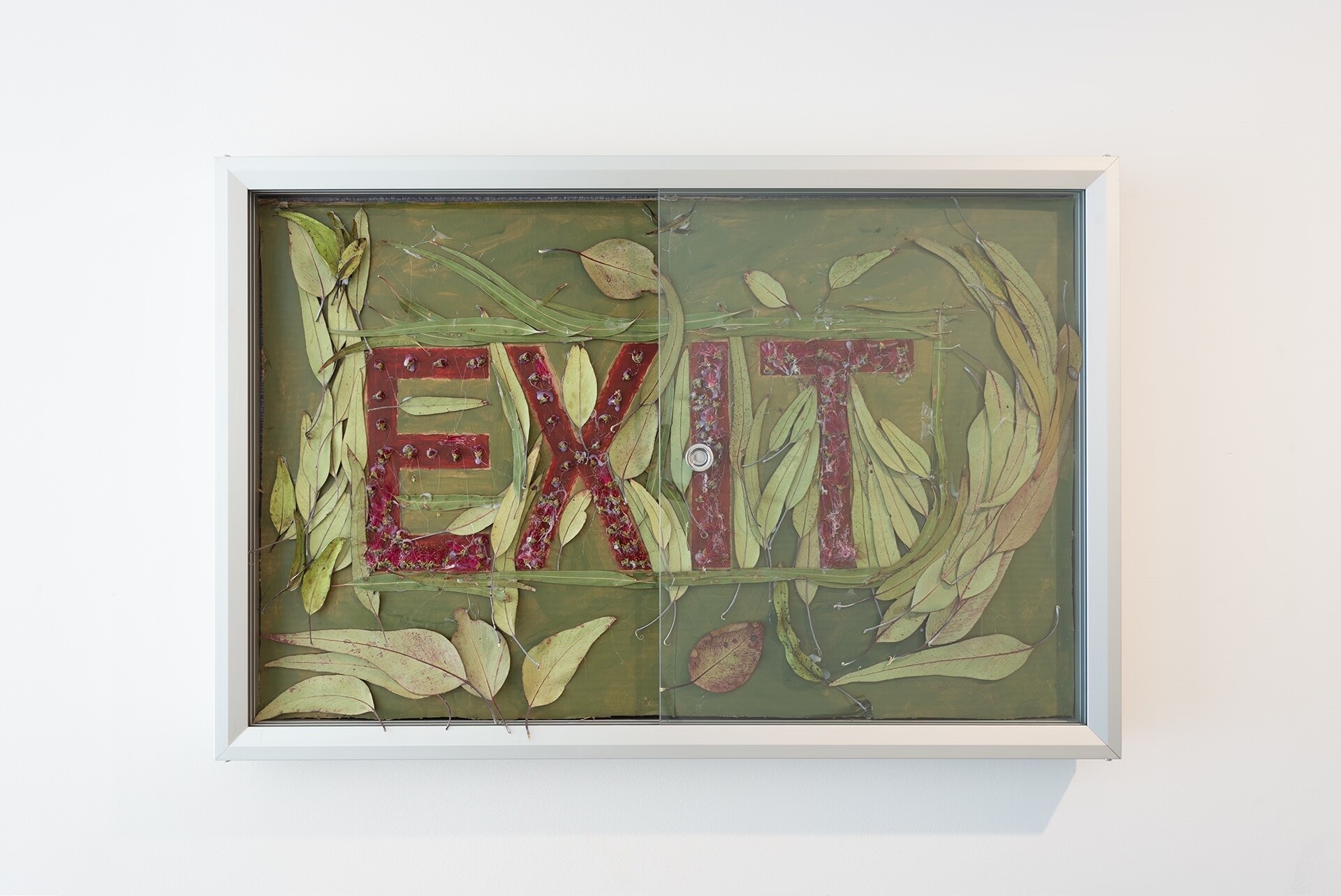 <p>Installation view of Katherine Botten, Exit Sign (Australia), 2022, eucalyptus leaves, gumnut blossoms, acrylic paint and cardboard, 211-215 Gallery. Photo: Aden Miller.</p>