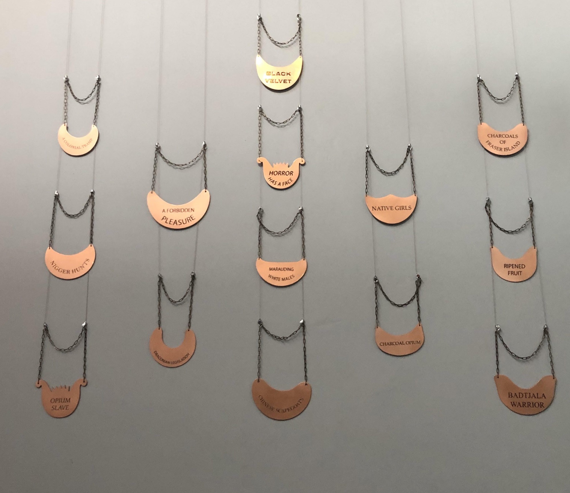 Fiona Foley, breastplates from the series <em>Horror has a Face</em>, brass and enamel paint, 2017.
