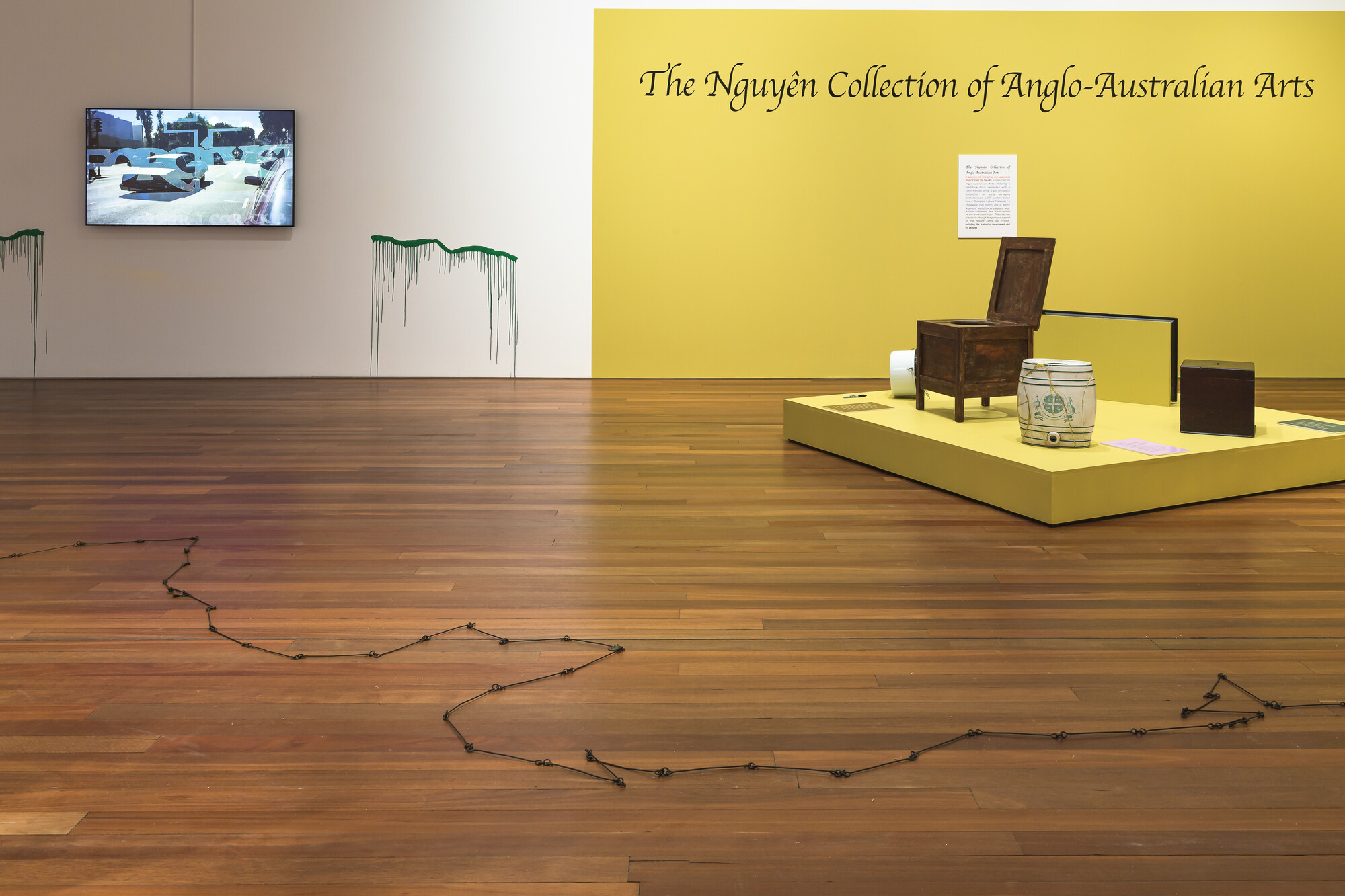 Install view: A park is not a forest, curated by Salote Tawale, Sydney College of the Arts. Right: James Nguyen, T<em>he Nguyễn Collection of Anglo-Australian Arts</em>, 2022. Mixed media. All objects acquired at auction by The Nguyễn Collection of Anglo-Australian Arts. Left: Claudia Nicholson, <em>An Old Spelling of My Name</em>, 2020. Single Channel HD Video (12:32). Sound by James Brown. This artwork was made with the support of Urban Theatre Projects. Photo: Document Photography