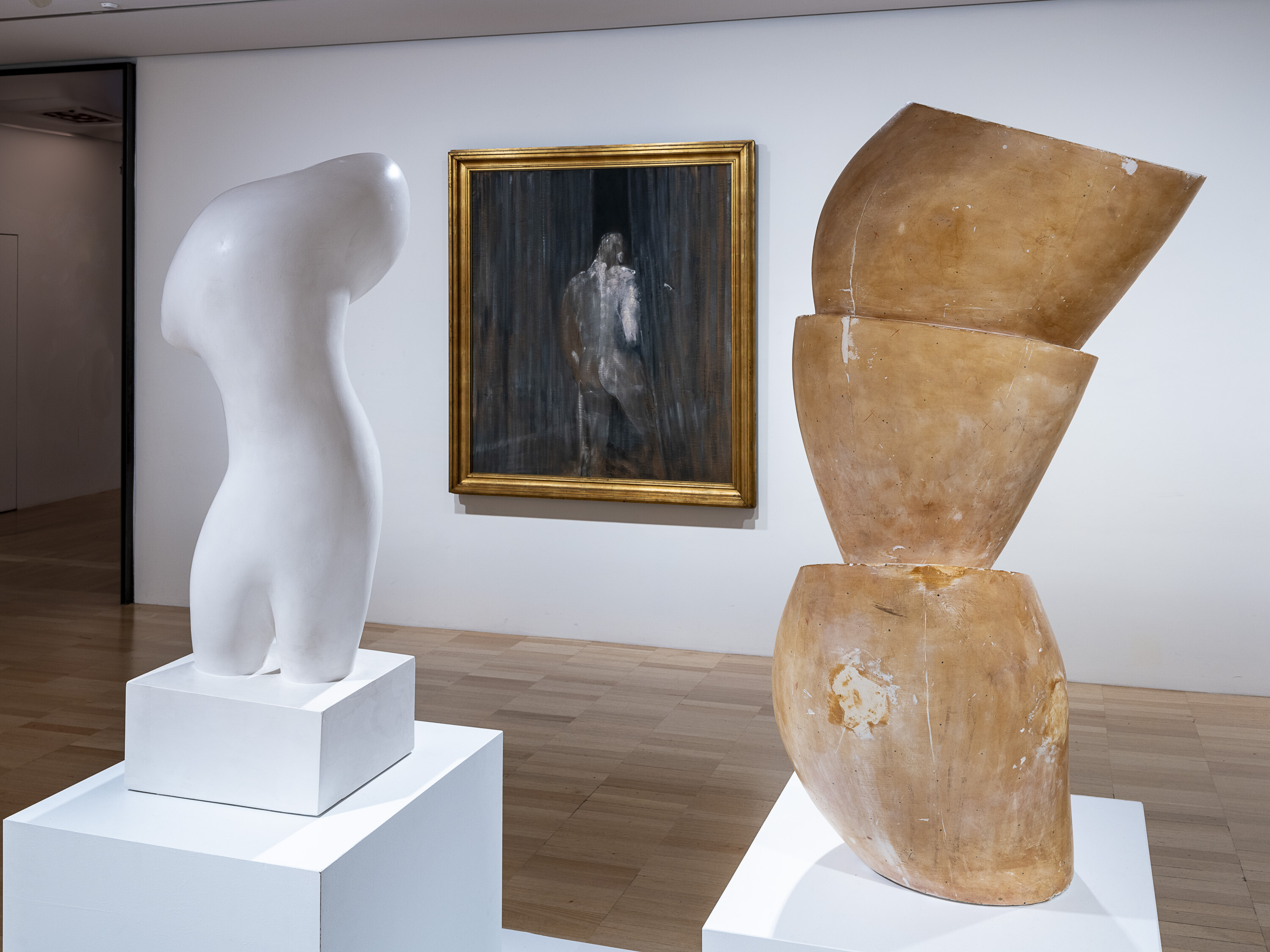 <p>Installation view of Francis Bacon, <em>Study from the Human Body</em>, 1949, oil on canvas, and Hans Arp <em>Torso</em>, 1953, cast 1960-82, plaster, and <em>Tree of Bowls</em>, 1947, cast c. 1970, plaster and shellac, on display at NGV International. Works by Hans Arp generously gifted by the artist’s estate Stiftung Arp e.V. Photo: Garry Sommerfeld.</p>