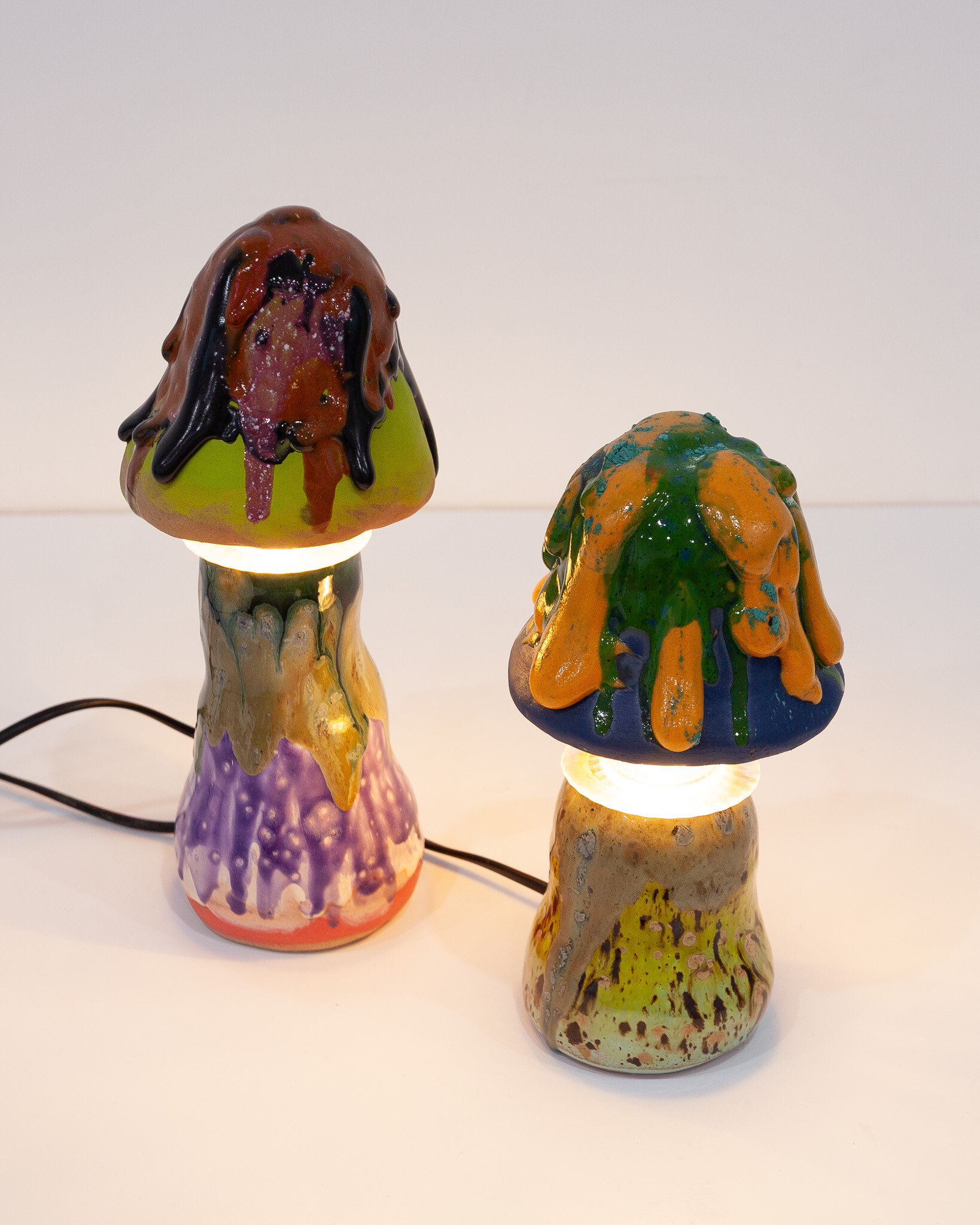 <p>Annie and Jonathan Zawada, left to right: <em>Mushroom Lamp Tall (Black Drip)</em>, 2026, ceramic and light fitting, 28 x 10 x 10 cm; <em>Mushroom Lamp Small (Orange Drip)</em>, 2026, ceramic and light fitting, 24 x 10 x 10 cm. Courtesy Animal House Fine Arts.</p>