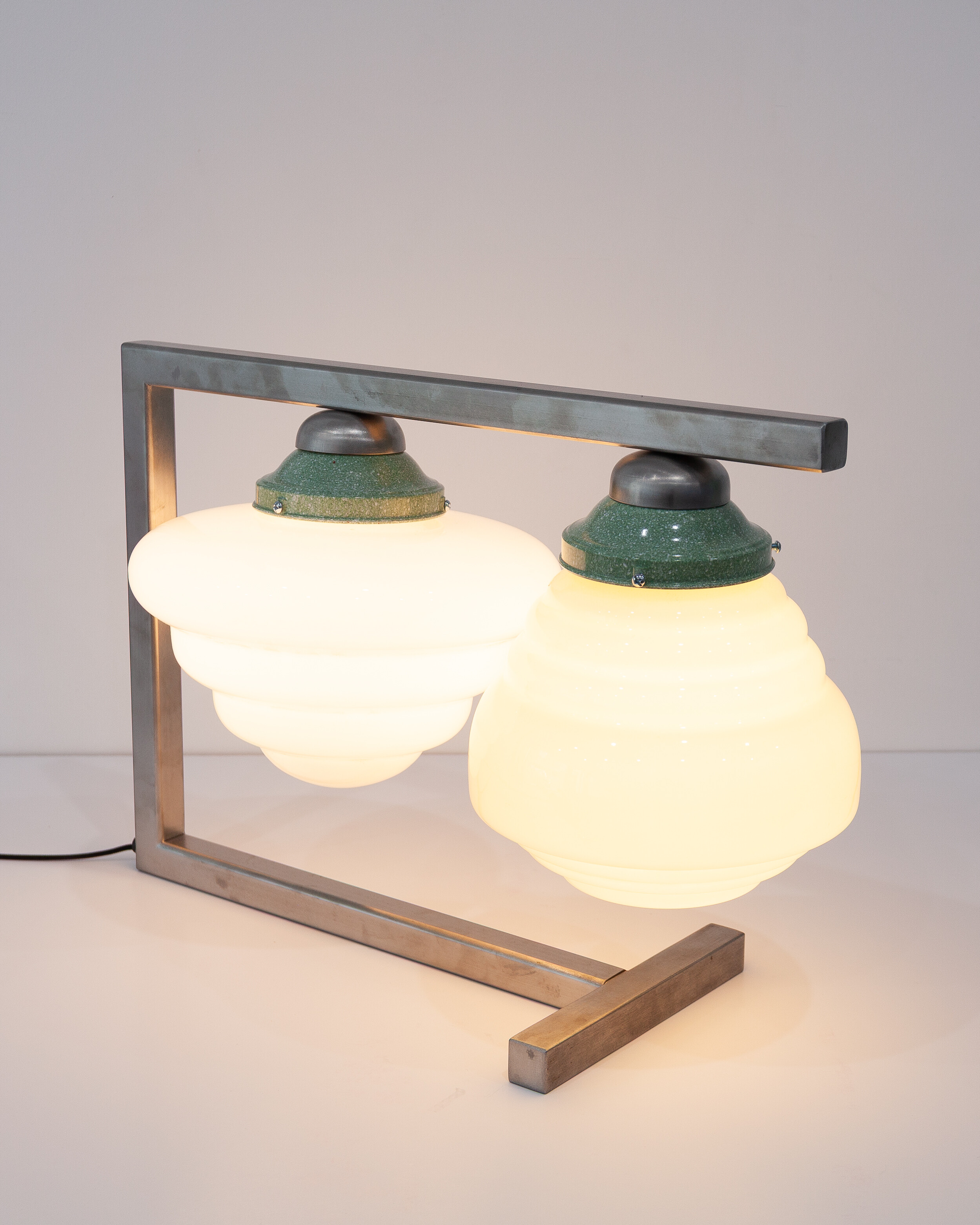 <p>Anna Varendorff, <em>Coppia Lamp</em>, 2026, stainless steel, glass, baker light, 12 volt wiring, 35 x 50 x 25 cm. Courtesy Animal House Fine Arts.</p>
