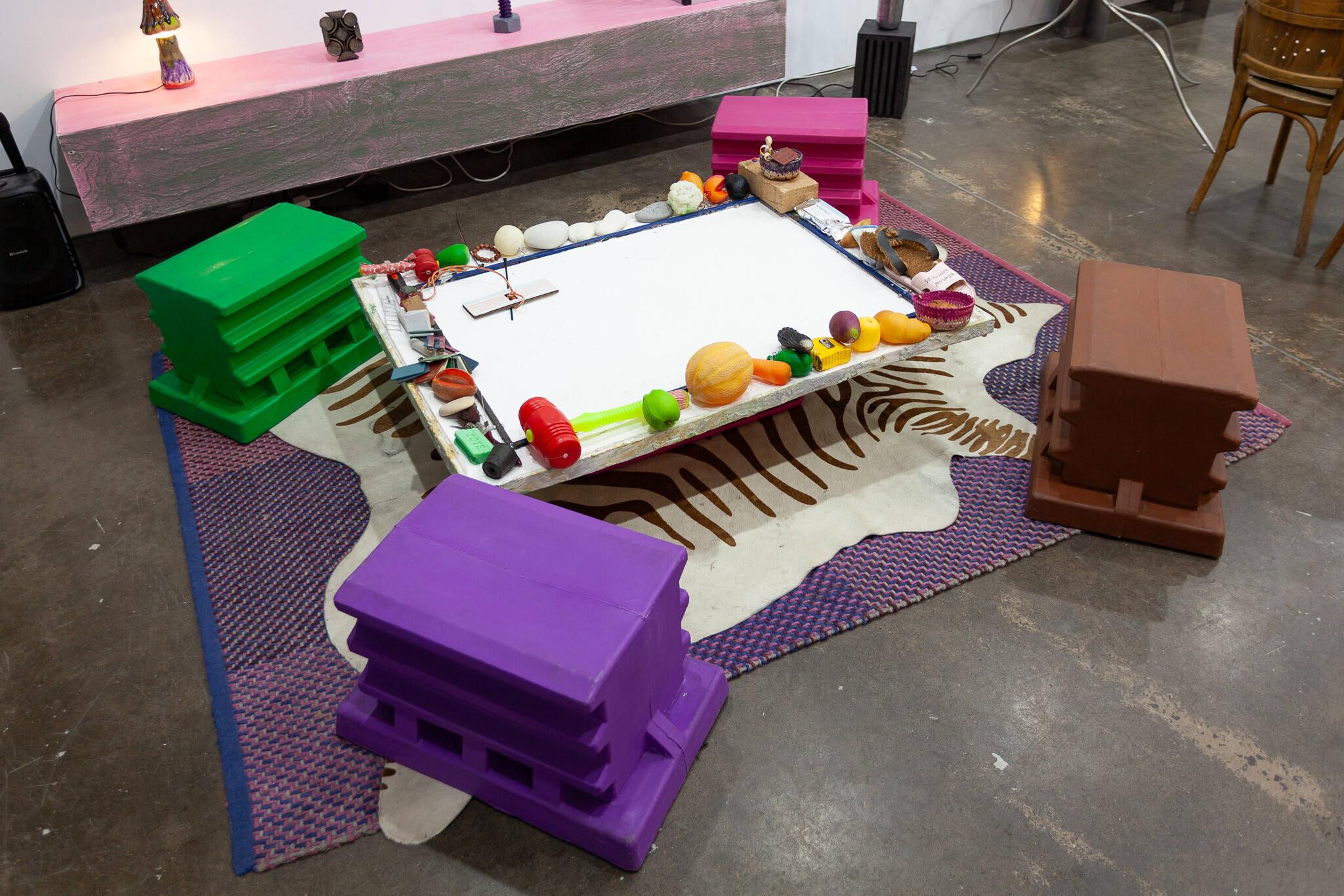 <p>Mike Hewson, <em>Double Rug Coffee Table #1</em>, 2025–26, polyurethane, custom-moulded extra-heavy-duty plastic tub, salvaged textiles, objects from studio, custom-moulded extra-heavy-duty plastic tubs. Courtesy Animal House Fine Arts.</p>