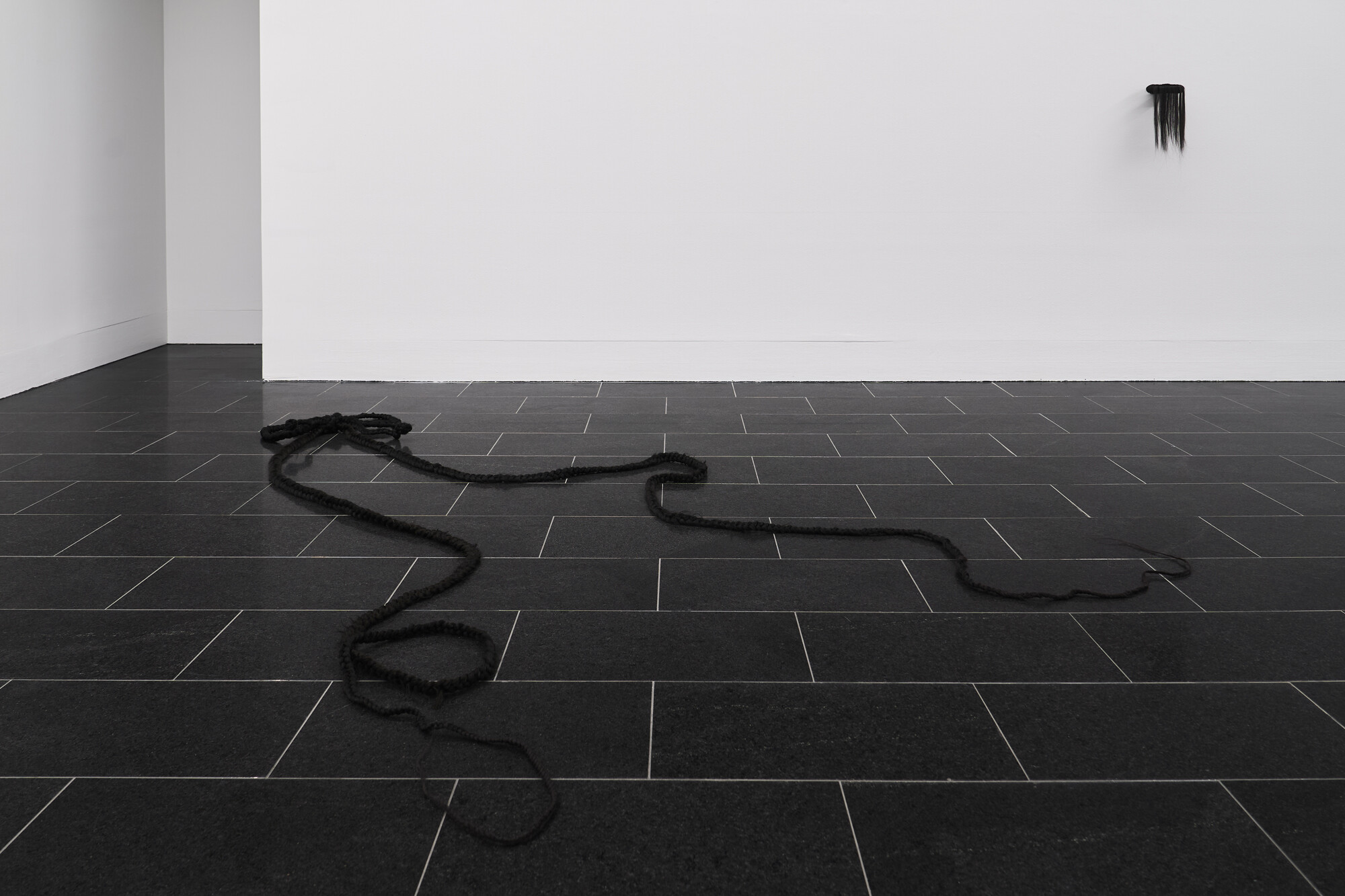 <p>Zeïna Thiboult,<strong> </strong><em>Hair Bow</em>, 2024, synthetic hair extensions, wire, 457 x 47 cm. <em>Black Halo</em>, 2022, synthetic hair extensions, polystyrene, 40 x 17 cm, courtesy of the artist. Photo: Leon Schoots</p>