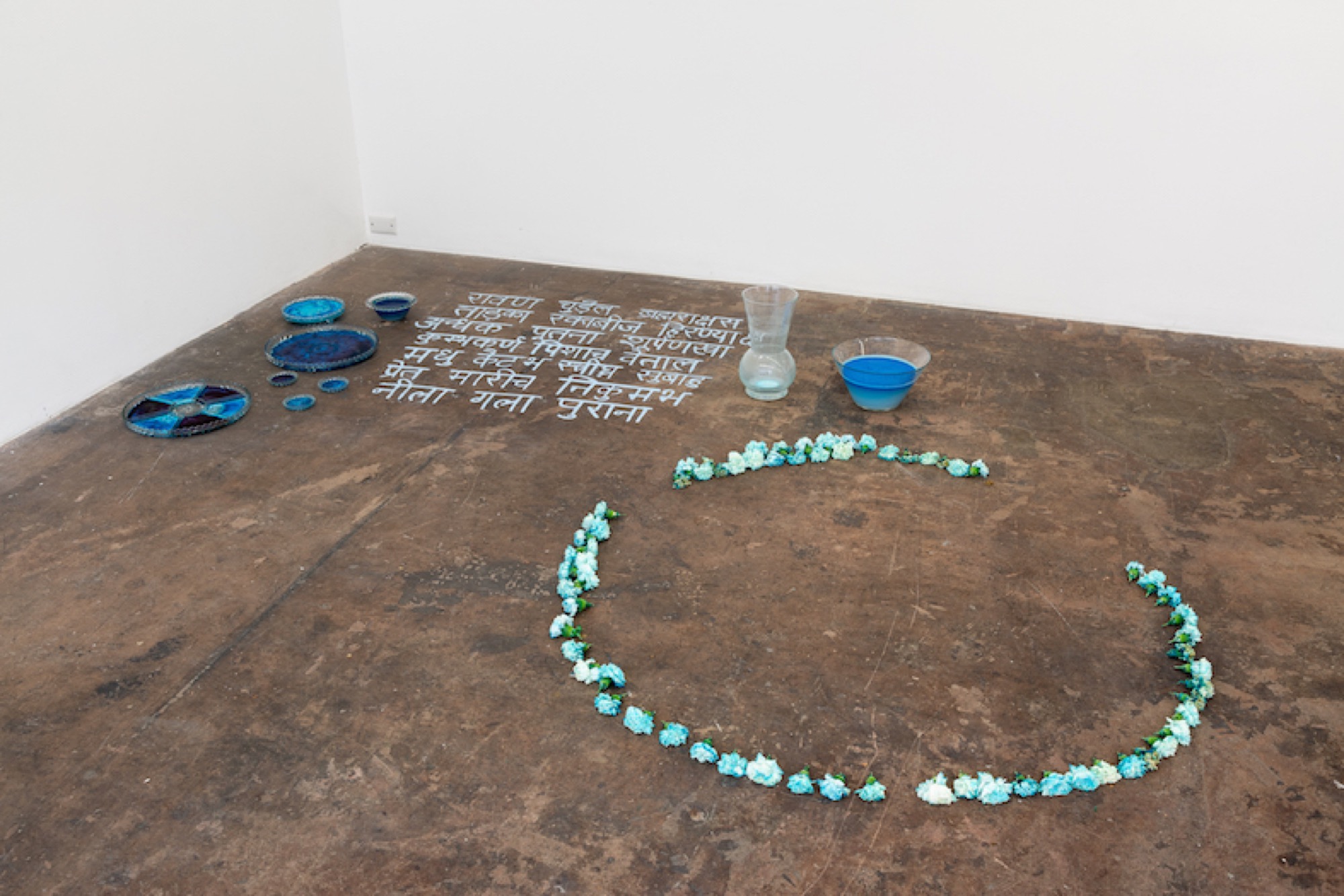 Manisha Anjali, <em>Old Blue Throat</em>, chalk, flowers, water, dye, glass dishes, installation view, 2019, image courtesy of gallery, photo: Christo Crocker.