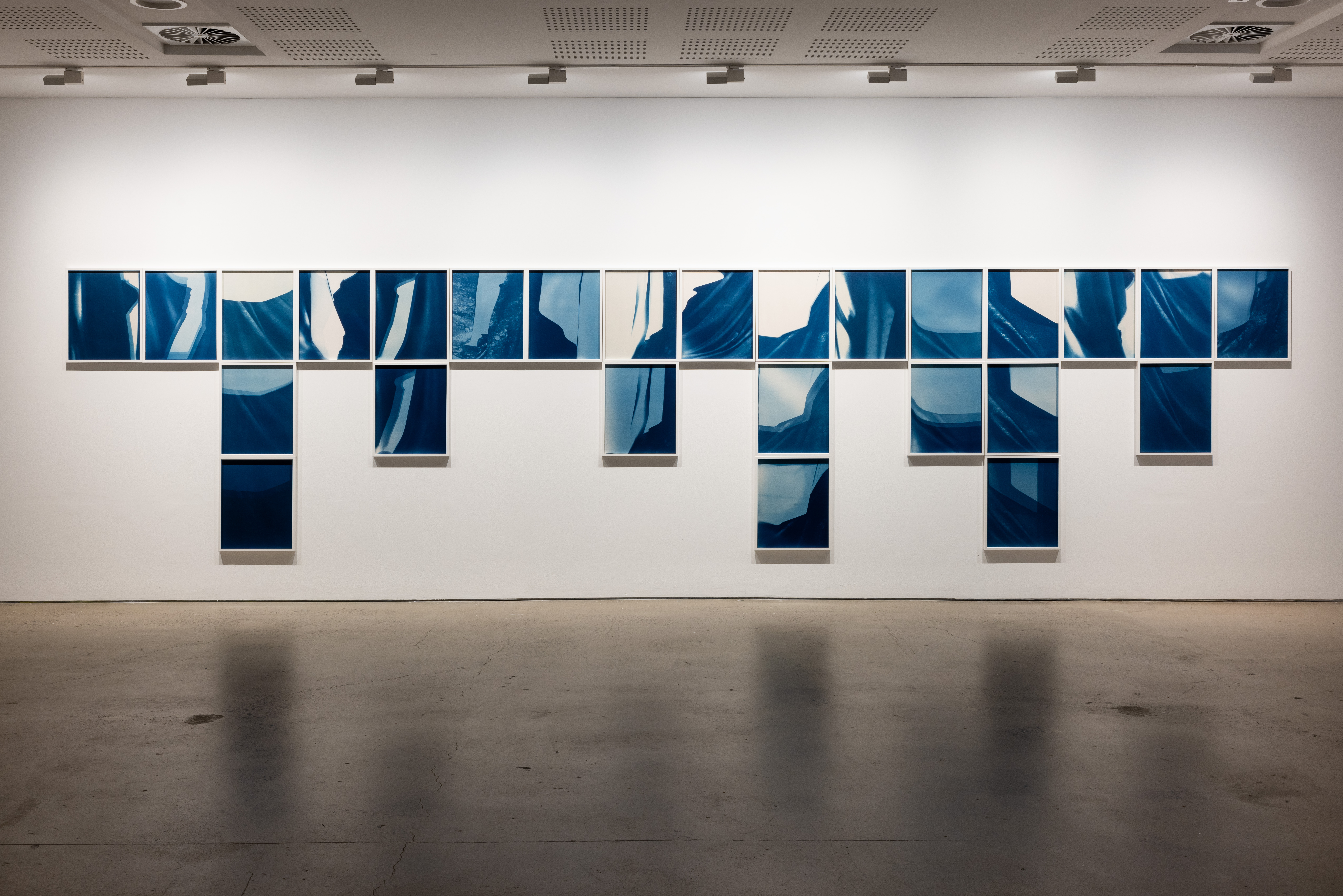 Installation view. Izabela Pluta, 26 Variations from Blue Spectrum and Descent (2020), cyanotypes on watercolour paper, UNSW Galleries, Sydney, 2022. Image courtesy the artist, UNSW Galleries and Gallery Sally-Dan Cuthbert. Photo: Daniel Boud.