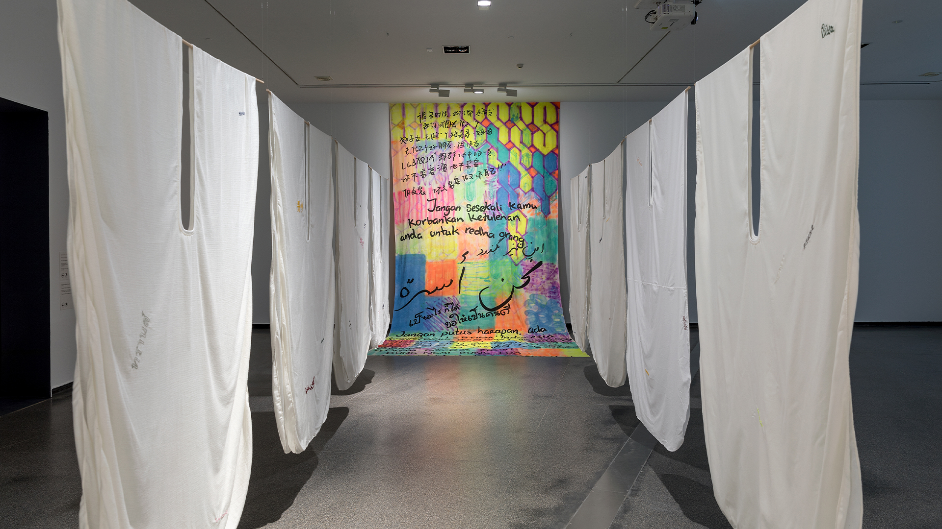 James Nguyen and Budi Sudarto, <em>Angel costumes</em> 2023; <em>Drop sheet</em> 2023, installation view, Australian Centre for Contemporary Art, Melbourne. Courtesy the artists. Photograph: Andrew Curtis