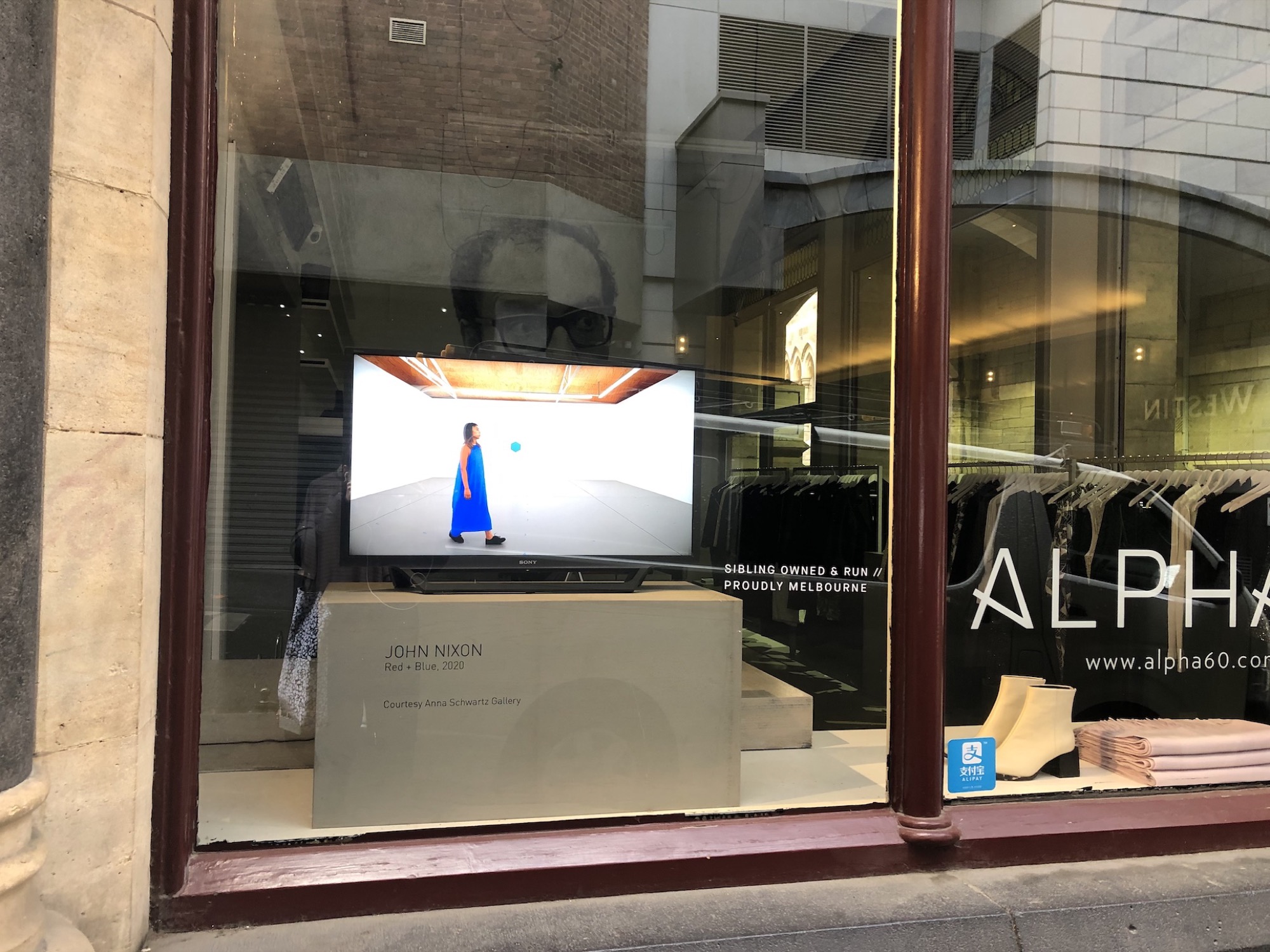 John Nixon, Red + Blue, 2020, 11 min 45 sec, featuring Grace Uchida and dresses by Alpha60, displaying in the window of Alpha60, 201 Flinders Lane, photo: Amelia Winata.