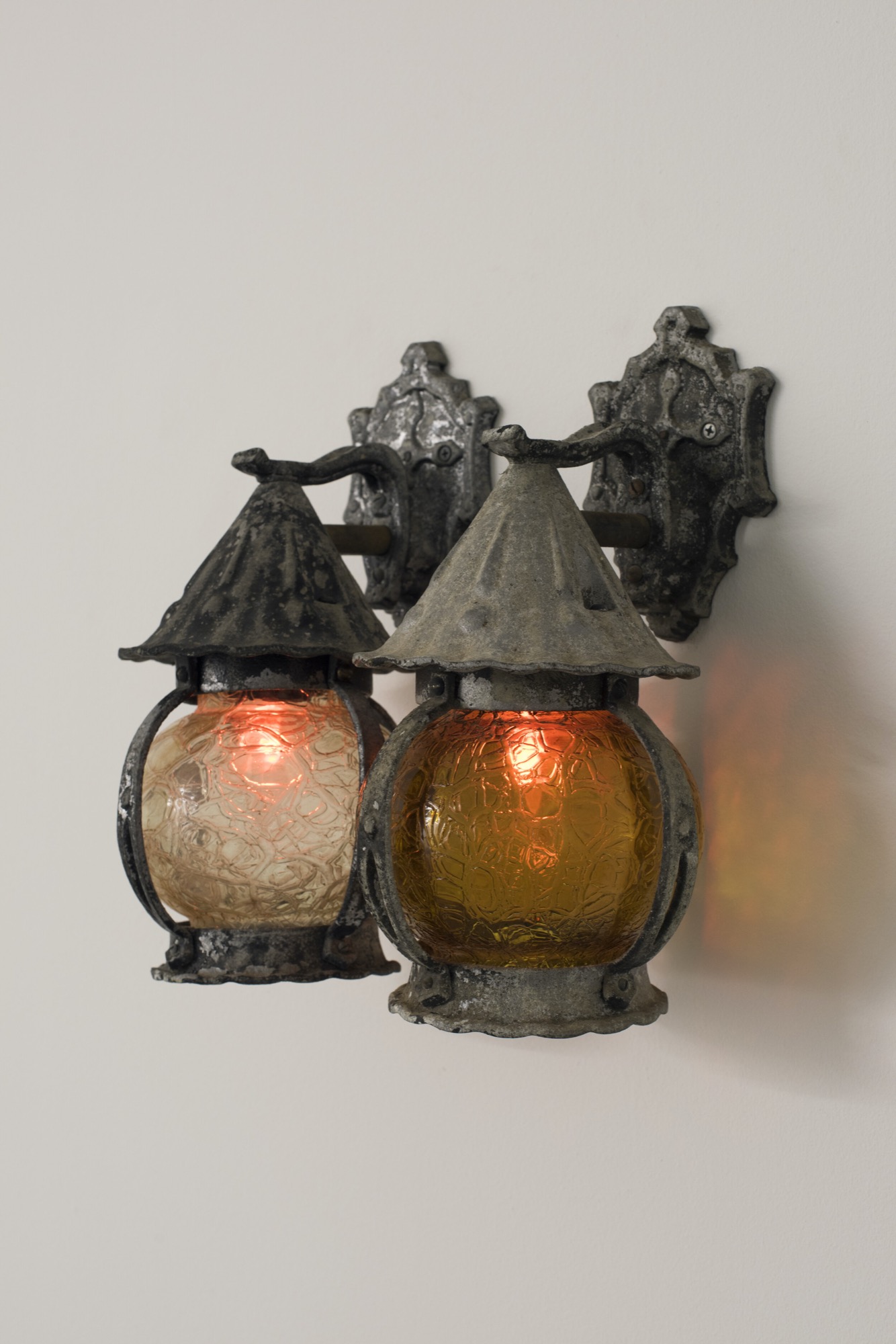 Weevils, 2020<br />
patinated cast metal, hand-blown glass, B22 ‘flame flickers’, wiring<br />
360 (h) x 160 (w) ea