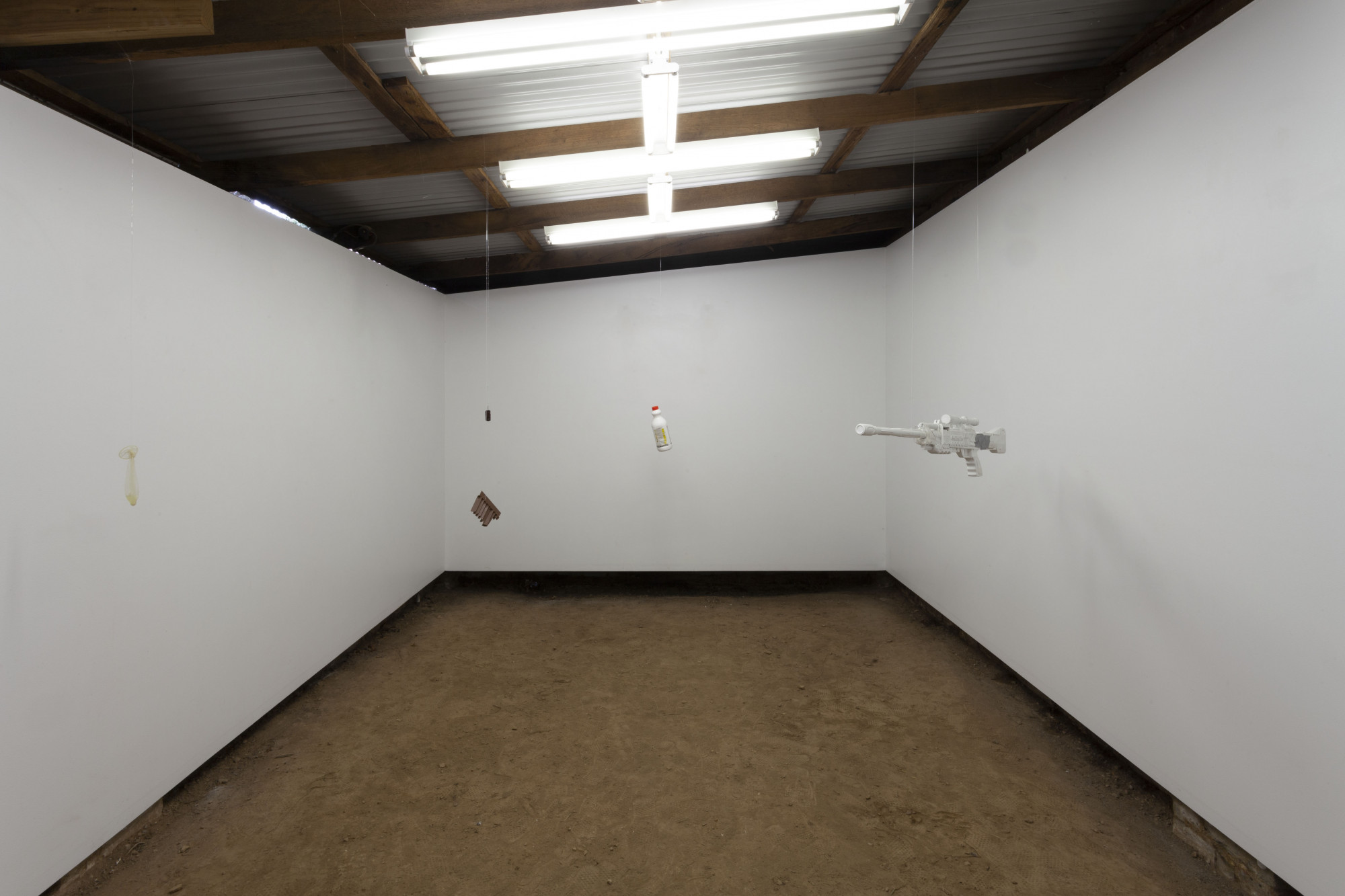 Installation view of John McCrackpipe and Alex Vivian, <em>First Person Shooter</em>, 5 September 2021, Guzzler. Used condom, broken vent guard, used tampon, bleach bottle, painted gun with tape. Photo: Courtesy of the artists.