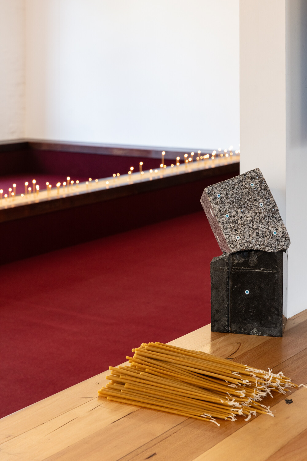 <p>Tina Stefanou, ‘Motet Fail’, 2026, concrete, carpet, wood, stone, granite, sand, beeswax, fire, installation view, West Space. Photography by Janelle Low.</p>