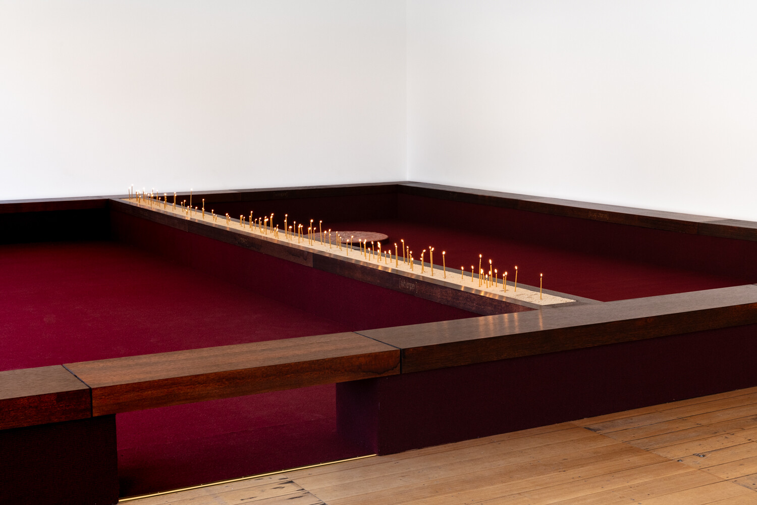<p>Tina Stefanou, ‘Motet Fail’, 2026, concrete, carpet, wood, stone, granite, sand, beeswax, fire, installation view, West Space. Photography by Janelle Low.</p>
