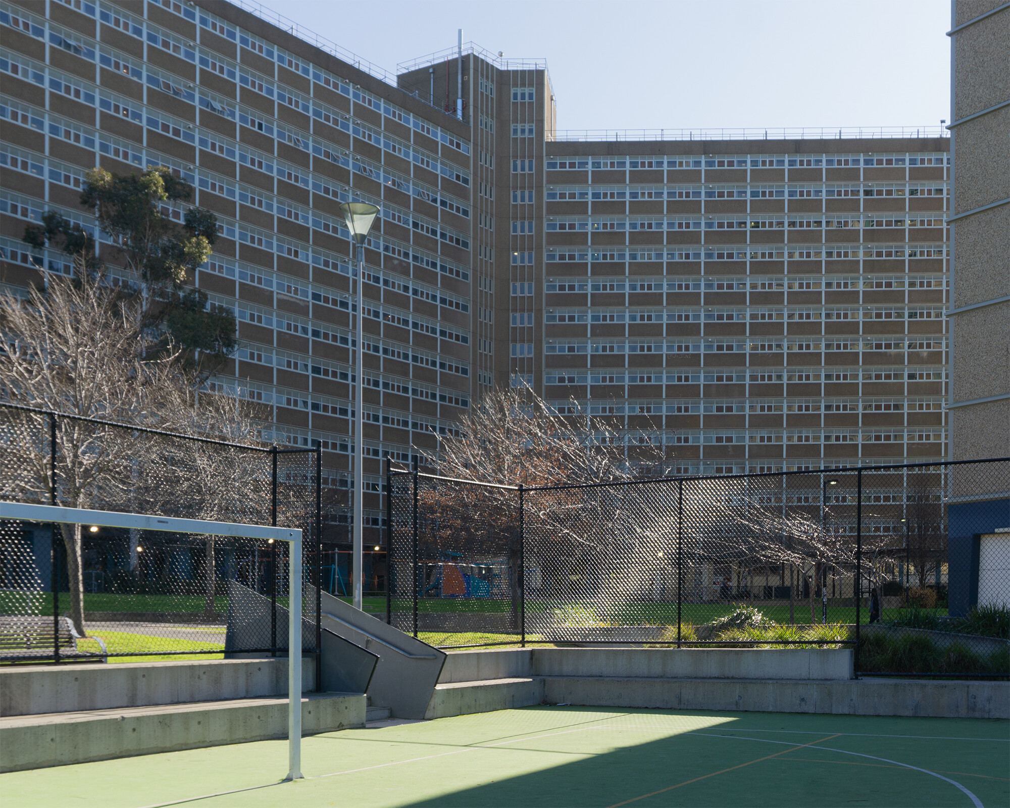 <p>The Carlton Public Housing Estate has been opened up to the rest of the suburb, with the inclusion of a futsal court at the base of the towers. Photograph by Veronica Charmont.</p>