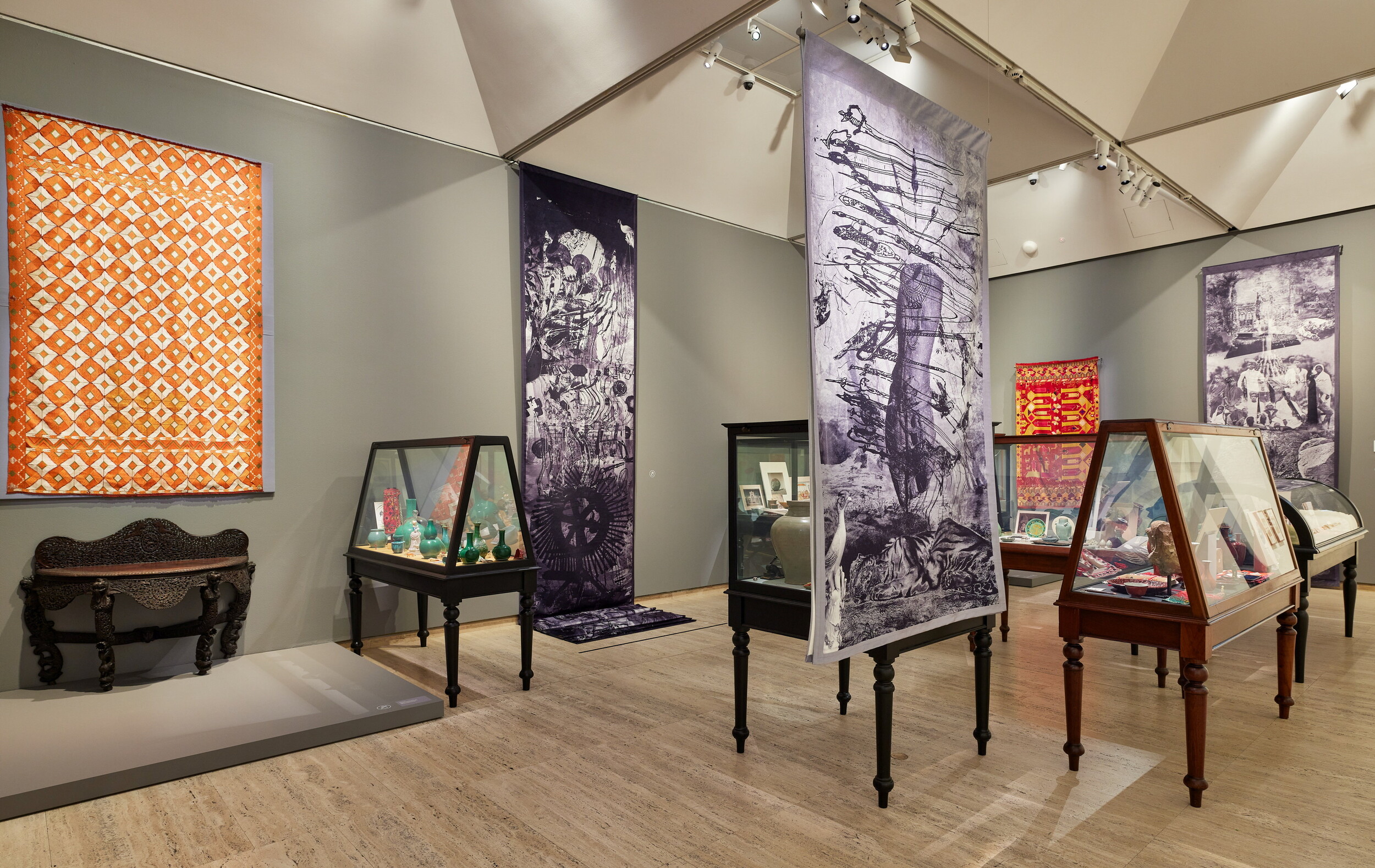 <p>Installation view of the <em><em>Nusra Latif Qureshi: Birds in Far Pavilions</em></em> exhibition at the Art Gallery of New South Wales, 9 November 2024 – 15 June 2025, featuring Nusra Latif Qureshi<em> <em>Museum of lost memories</em></em> 2024, site-specific installation comprising objects from the artist’s personal archive, works from the Art Gallery of New South Wales collection, objects on loan from the Powerhouse Museum, and banners produced by the artist © Nusra Latif Qureshi. Photo © Art Gallery of New South Wales, Felicity Jenkins</p>