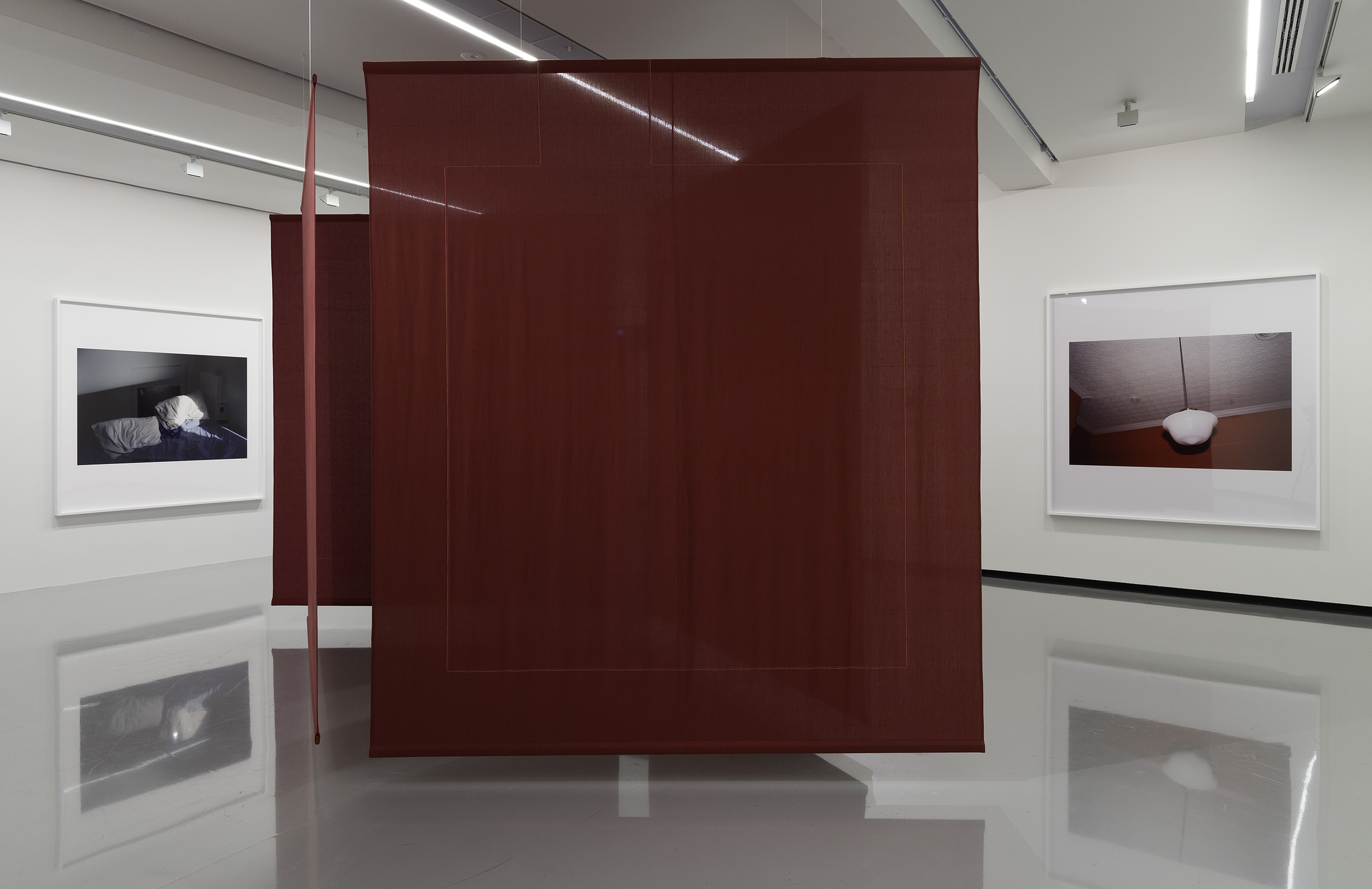 Installation view of Paul Knight, untitled photographs from the series <em>Chamber Music</em>, 2009–, and <em>Lungs</em>, 2023, handwoven cotton bedsheets, wood and stainless steel. Courtesy of the artist and Neon Parc, Naarm/Melbourne. <em>Paul Knight: L’ombre de ton ombre</em>, Monash University Museum of Art, Naarm/Melbourne, 2023. Photo: Christian Capurro
