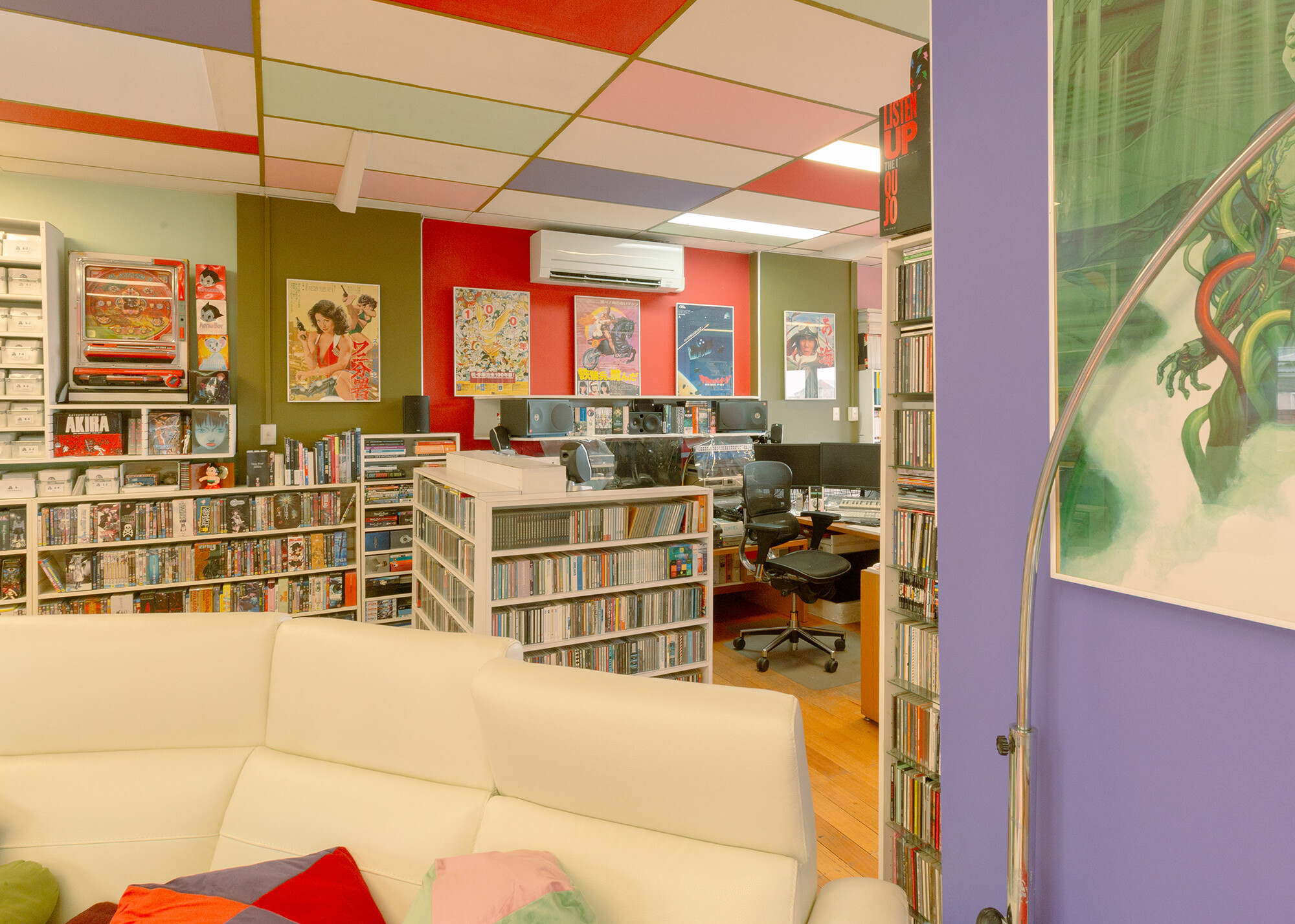 <p>The upper level of Philip Brophy’s house, with his couch in the foreground and desk in the background. Photograph by Laura Banfield.</p>