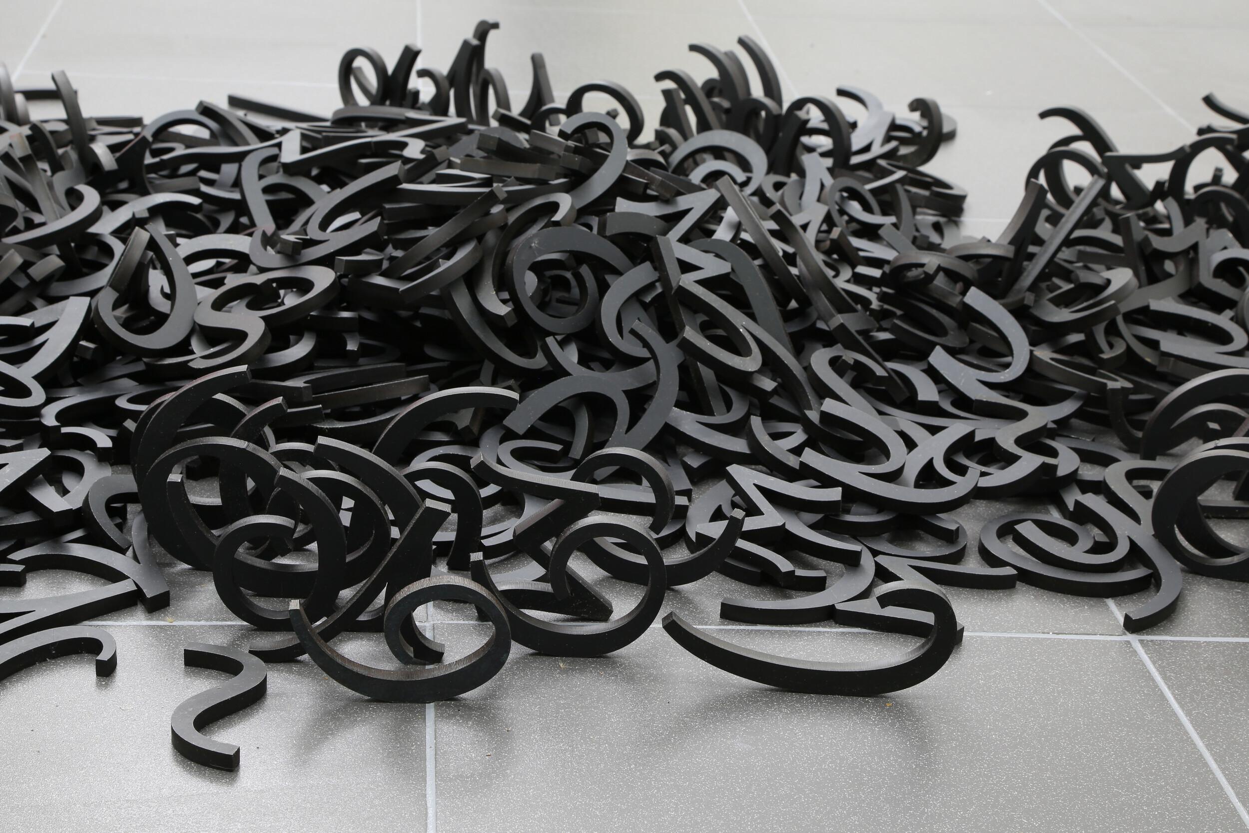 <p>Installation view of Emily Floyd, <em>Kesh Letterpress</em>, 2017, steel with black oxide coating, dimensions variable, HAIR. Photo: HAIR.</p>