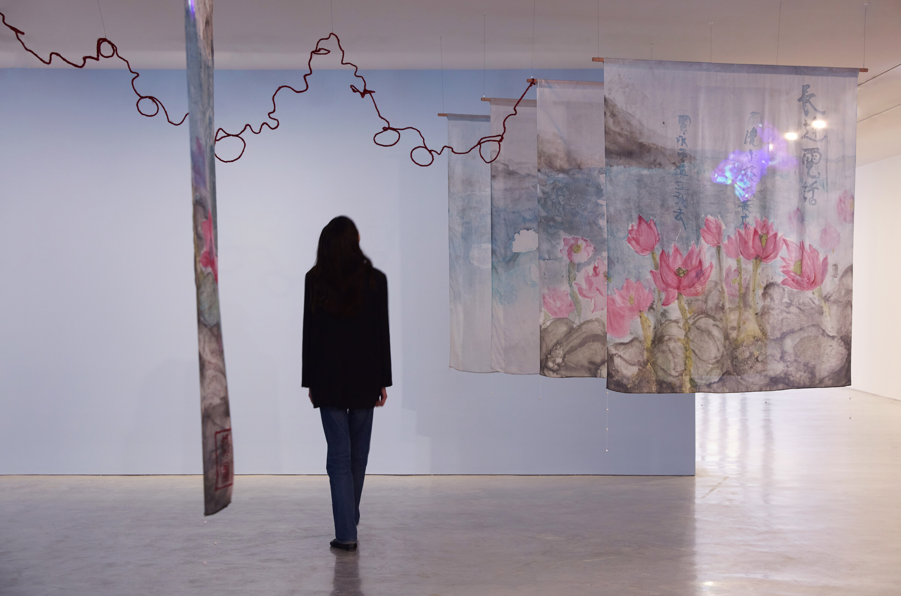 <p>Chun Yin Rainbow Chan (陳雋然), <em>Long Distance Call </em>長途電話 (detail), 2024, installation view, <em>Primavera 2024: Young Australian Artists</em>, Museum of Contemporary Art Australia, Sydney, 2024, silk dye on habotai silk, wax resist, freshwater pearls, linocut print, jute twine, digital animation projection, audio track, image courtesy the artist and Museum of Contemporary Art Australia © the artist, photograph: Zan Wimberley </p>
