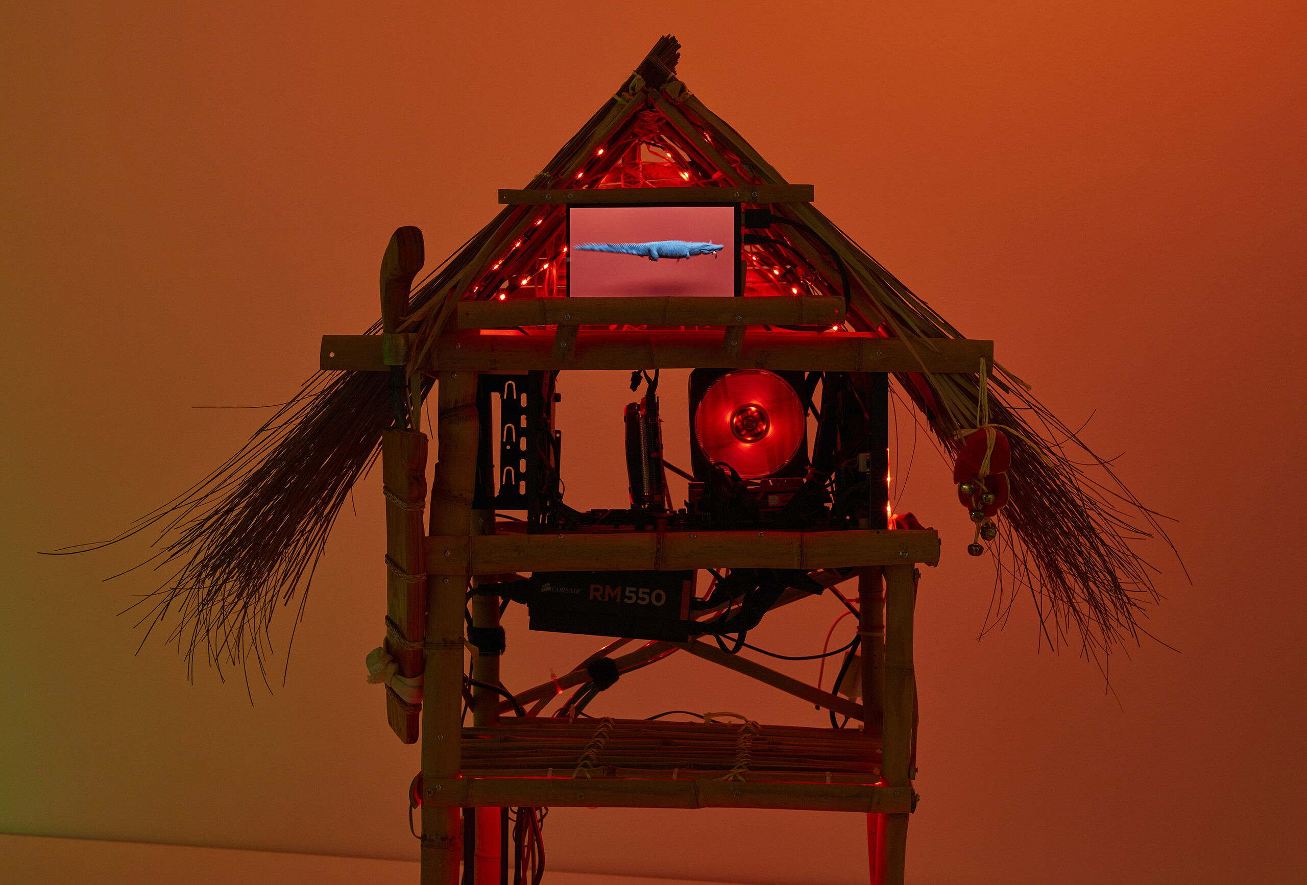 Tiyan Baker, <em>Personal computer: ramin ntaangan</em> (detail), 2022–23, installation view, <em>Primavera 2023: Young Australian Artists</em>, Museum of Contemporary Art Australia, Sydney, 2023, computer parts, computer monitors, screensaver video, bamboo, wood, palm and coconut leaf, plastic twine, heirloom machete, sunflower seeds, LED lighting, foam, spray paint, lucky bamboo, image courtesy and © the artist, photograph: Zan Wimberley