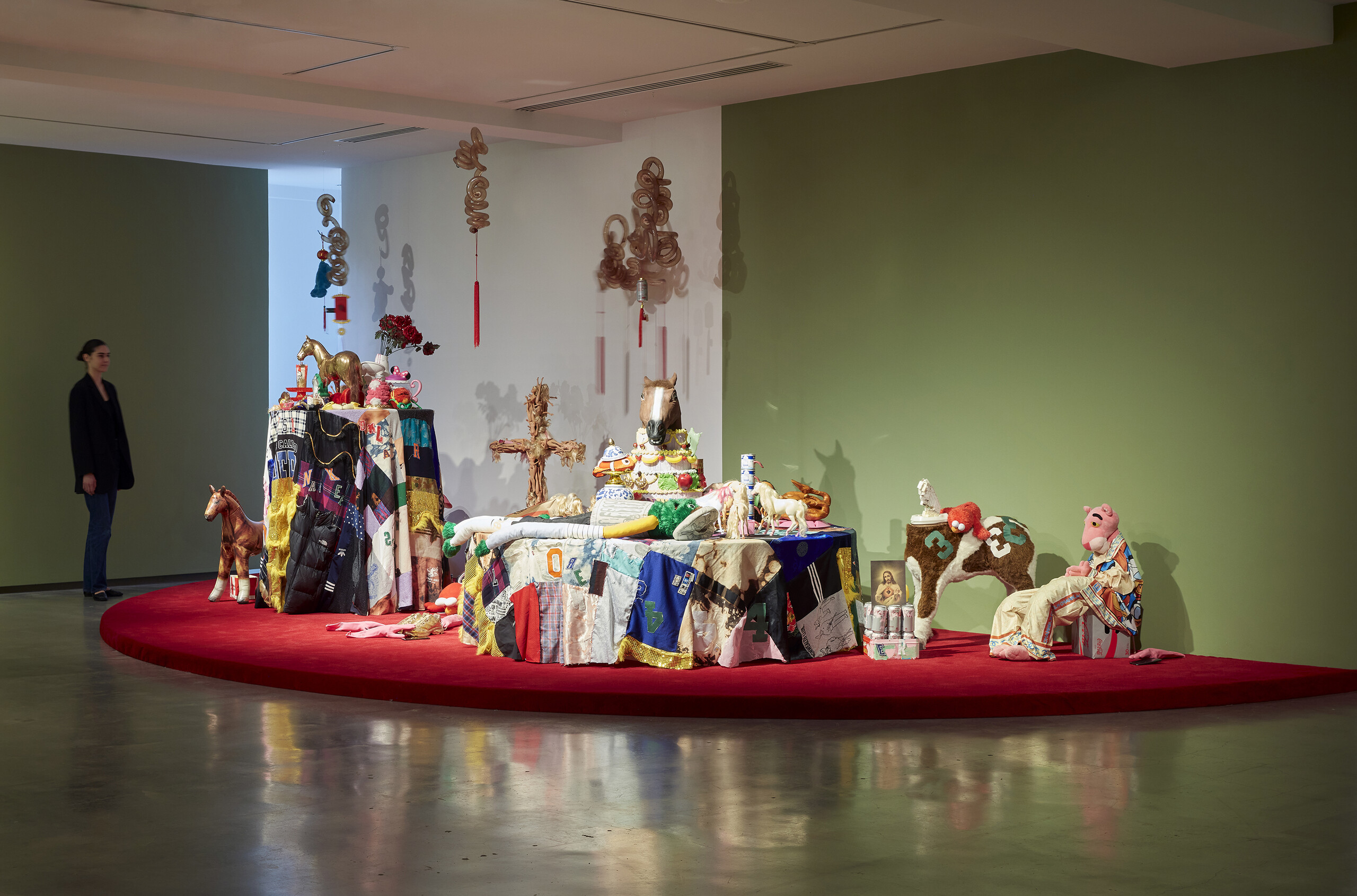 Truc Truong, <em>I Pray You Eat Cake</em>, 2023, installation view, <em>Primavera 2023: Young Australian Artists</em>, Museum of Contemporary Art Australia, Sydney, 2023, toys, found objects, packaged food, synthetic polymer paint, fabric, wood, aluminium, stainless steel, electromechanical components, dried pig intestines and trotters, dried chicken feet, tassels, rope, image courtesy and © the artist, photograph: Zan Wimberley