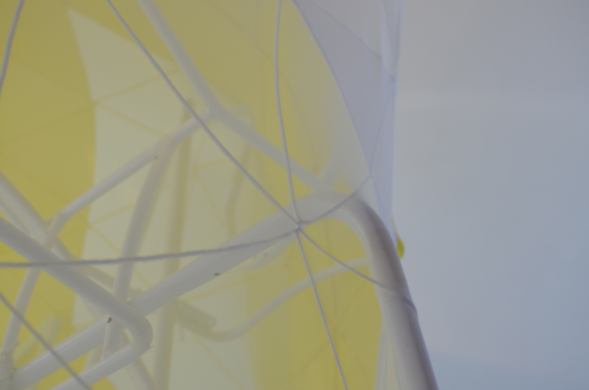 Melanie Irwin, <em>Hemispherical Envelope (Yellow, White)</em>, 2017, found, modified metal frames, lycra, cotton twine, electrical tape, dimensions variable.