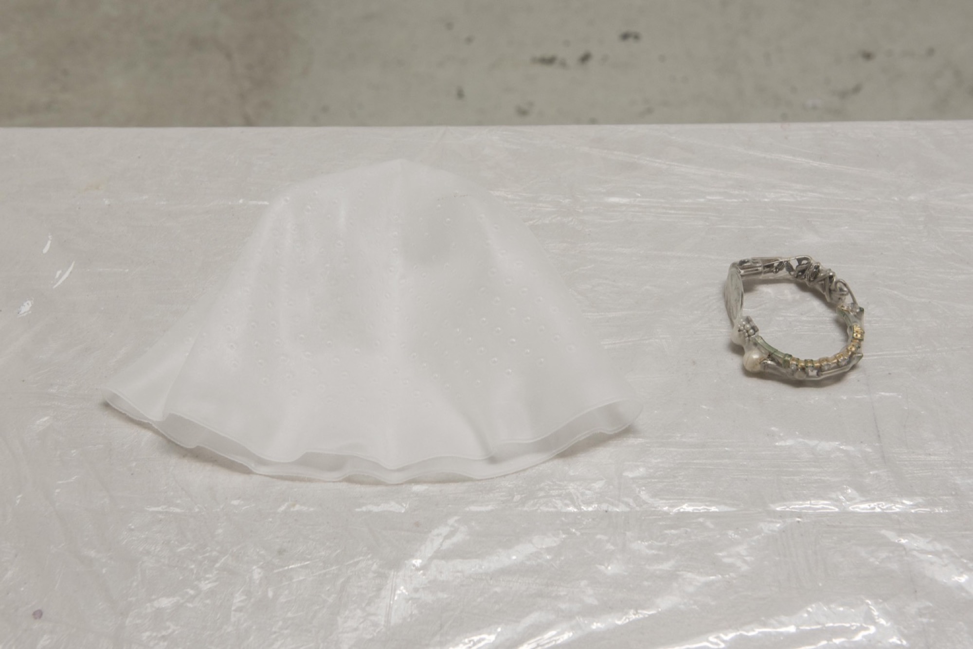 Rex Veal, <em>Bucket Hat</em> (left) <em>Bracelet</em> (right), 2020, rubber, plastic, cultured pearls, synthetic pearls, various metal components, found jewellery parts. Dimensions variable. Bossy’s Gallery. Courtesy of Bossy’s gallery. Photo: Jordan Halsall