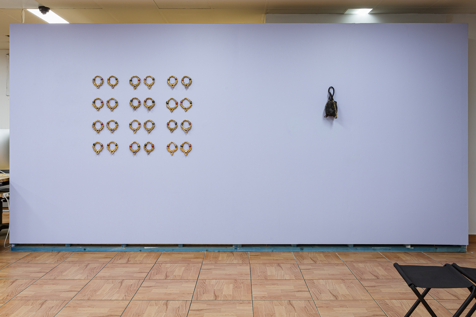 Left: Monica Rani Rudhar, <em>Daughter of the Same House</em>, 2021, glazed terracotta, gold lustre 15 cm × 30cm (each), installed 160cm × 100cm. Right: Edwina Green, (Untitled) Kelp Bag, 7, 2019–ongoing body of work, harvested nerocystis luetkeana, natural fibre twine, 12 cm × 32 cm. Photo: Document Photography.