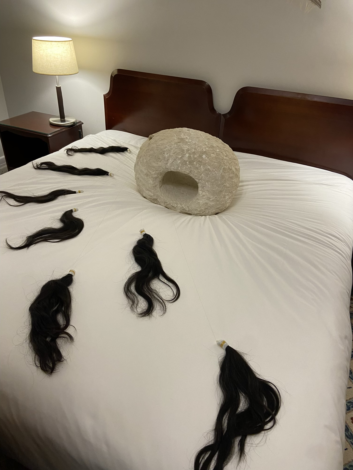 Noriko Nakamura, <em>Emptiness II</em>, 2022, artist’s hair, limestone, silk, Japanese washi paper, dimensions variable (limestone sculpture size: 46cm x 53cm x 34cm). Courtesy Caves Gallery.