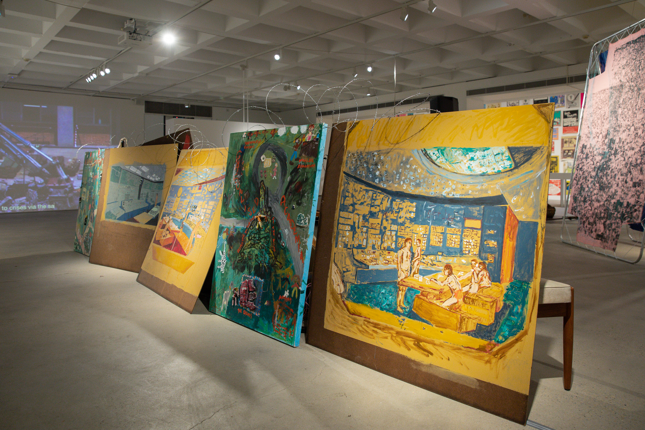 Zoë Marni Robertson, <em>Mid-Century Barricade</em> (2022), paintings with (found/borrowed) furniture, dimensions variable. Paintings: <em>Design Classic: Control I (The Welfare State)</em>, <em>Design Classic: Control II (Mutually Assured Destruction)</em>, <em>Design Classic: Control III (Nostalgia for a Future)</em>, <em>Design Control IV (Public Interest)</em>, 2022, Acrylic on (found) masonite. Photo: Maja Baska