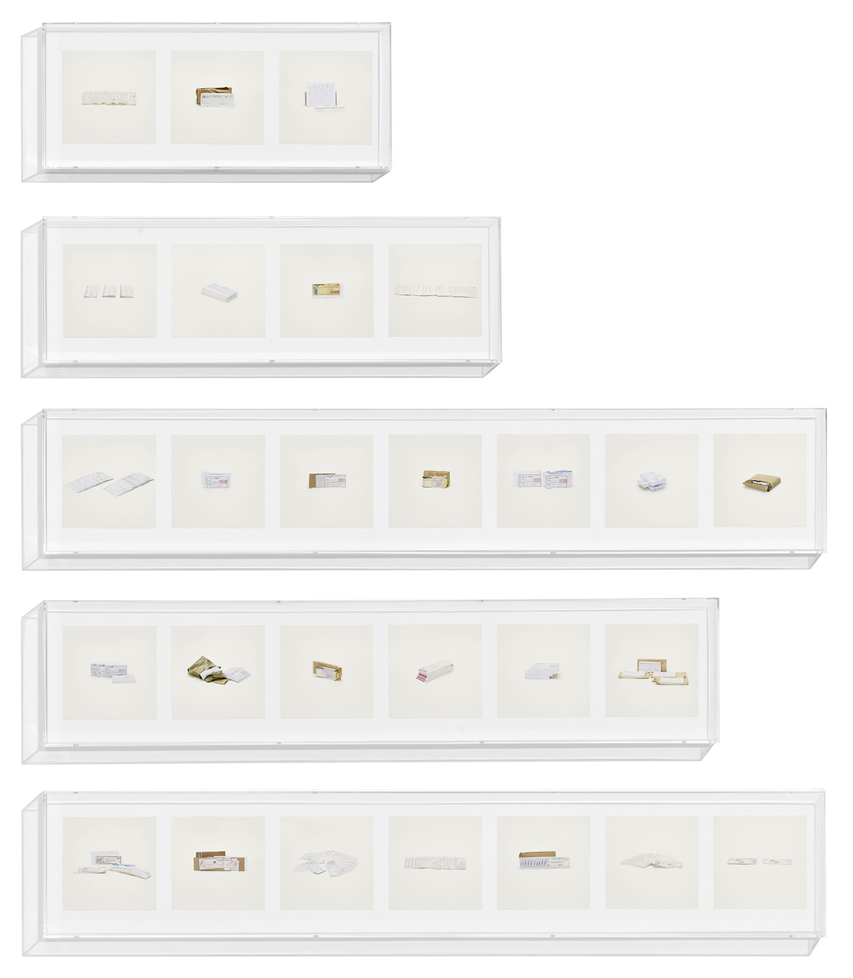 Cashier&#39;s Checks (Counterfeit), Checks (Counterfeit), Money Orders (Counterfeit), Traveler&#39;s Cheques (Counterfeit)<em>, Contraband</em>, 2010, 27 archival inkjet prints in 5 Plexiglas boxes and Letraset on wall, 9 1⁄4 x 22 3⁄4 (#1); 30 (#2); 51 3⁄4 (#3, 5); 44 1⁄2 (#4) inches (23.5 x 57.8; 76.2; 131.4; 113 cm)  © Taryn Simon. Courtesy Gagosian and Anna Schwartz Gallery.