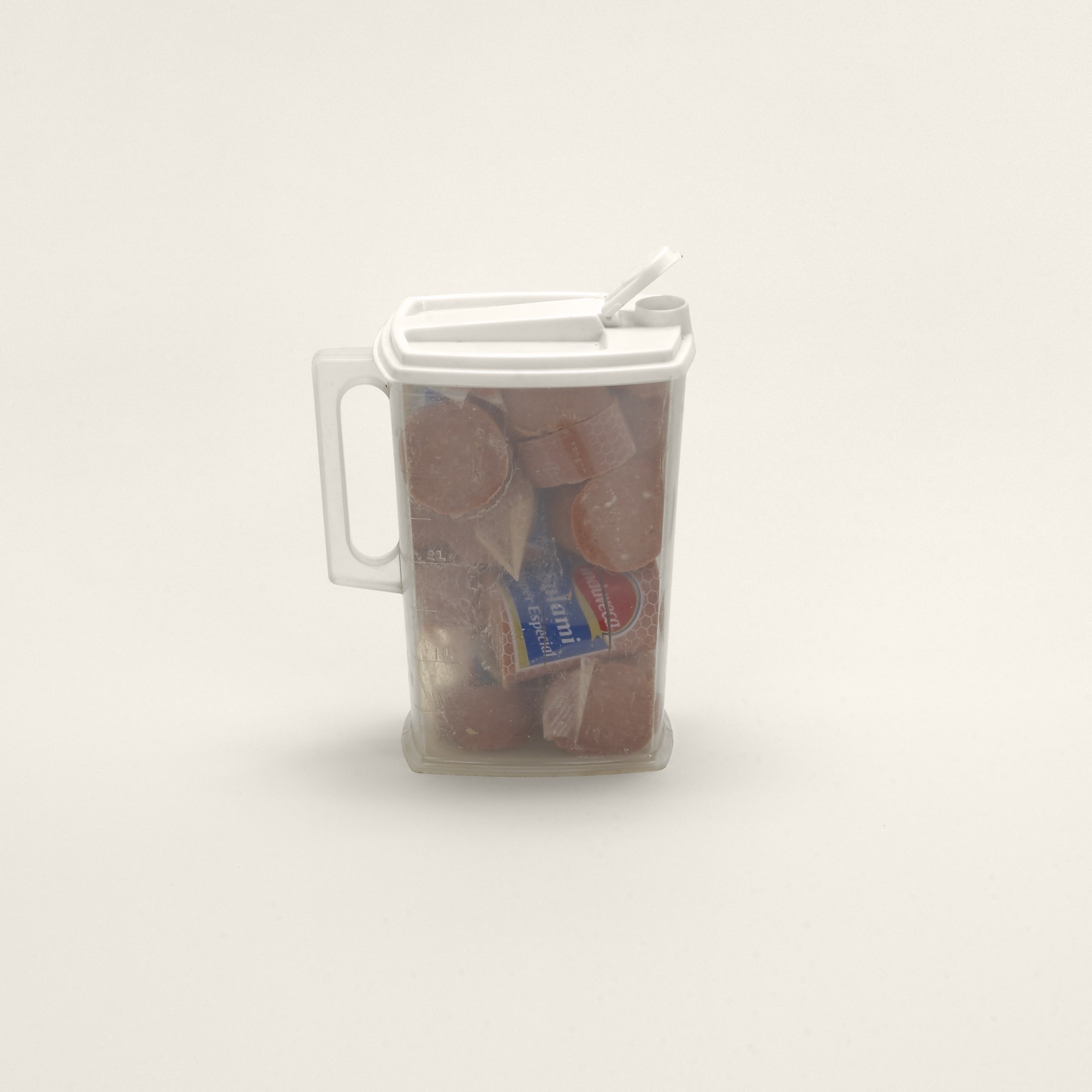 “Plastic pitcher of salami, Eastern Europe (9CFR.94) (prohibited)” (Detail) Sausages (Prohibited)<em>, Contraband</em>, 2010 , Archival inkjet print, 6 1⁄4 x 6 1⁄4 inches (15.9 x 15.9 cm) © Taryn Simon. Courtesy Gagosian and Anna Schwartz Gallery.
