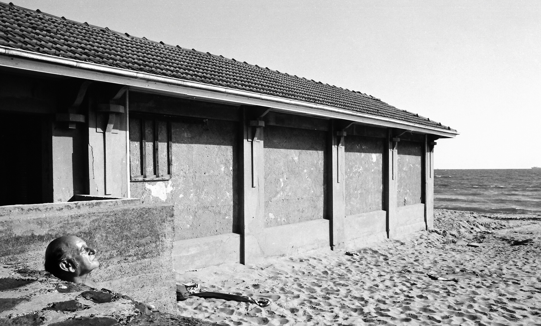<p>Geoff Strong, <em>Bald man enjoying the sun, St Kilda, </em>1975, silver gelatin print. Courtesy of the artist.</p>