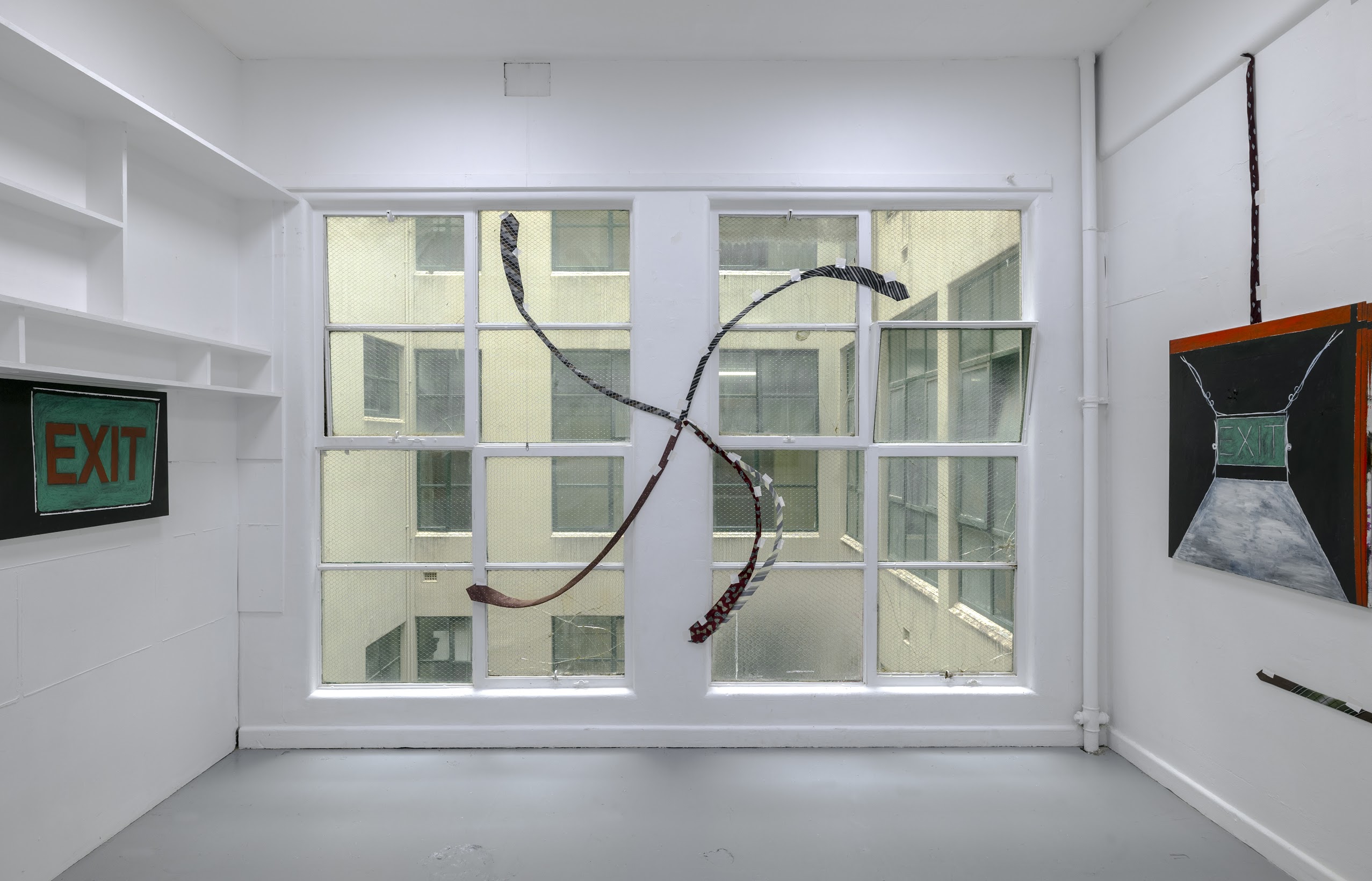 Katherine Botten, <em>Tie work 1 (A swastika straightens out)</em> (Window), ties, gaffa tape. Dimensions variable. 2022. Photo: Kenneth Suico.