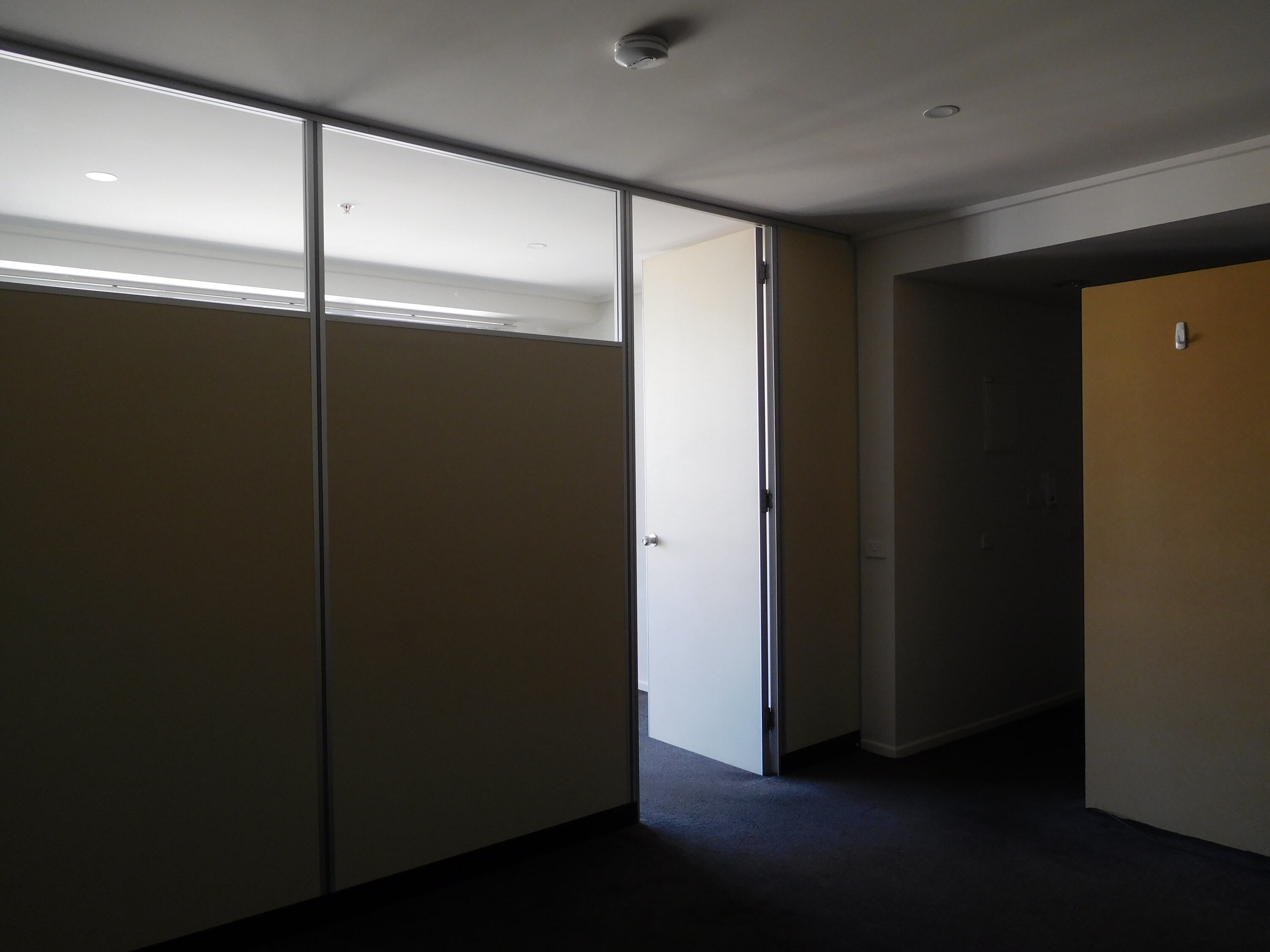 <p>Interior view of the “three-bedroom” apartment available to rent showing the “fake wall”. Photograph by author.</p>